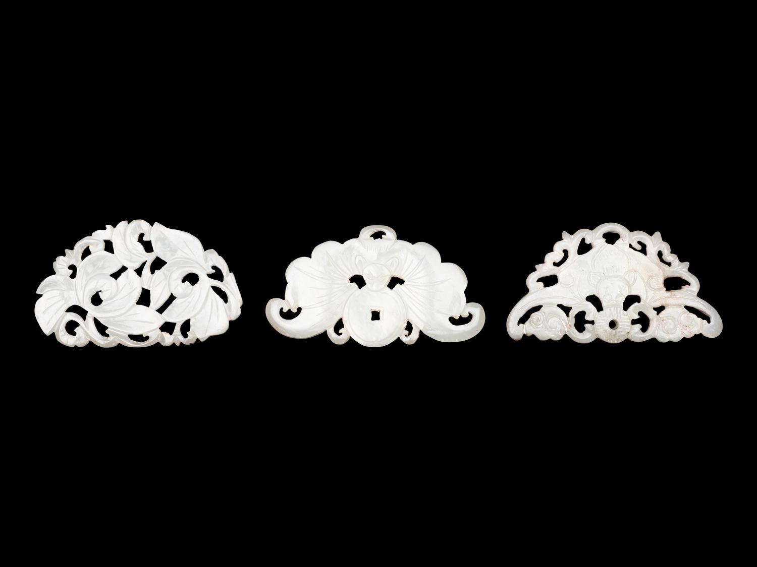 Three Chinese Pale Celadon Jade Reticulated Flori-Form Pendants