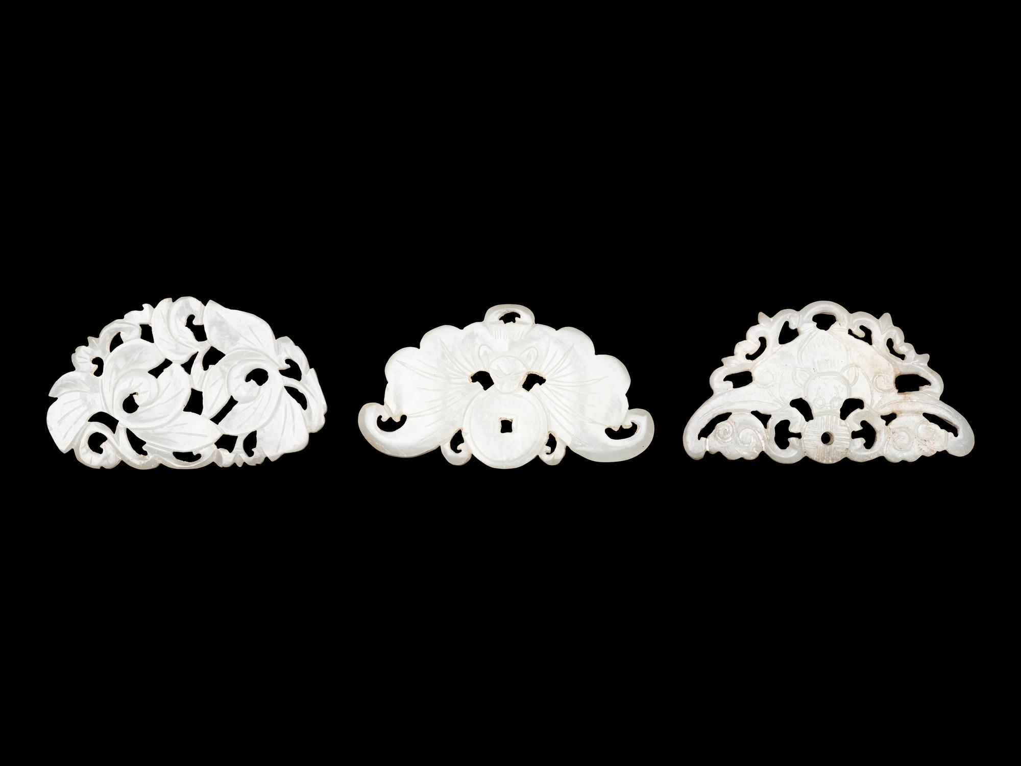 Three Chinese Pale Celadon Jade Reticulated Flori-Form Pendants