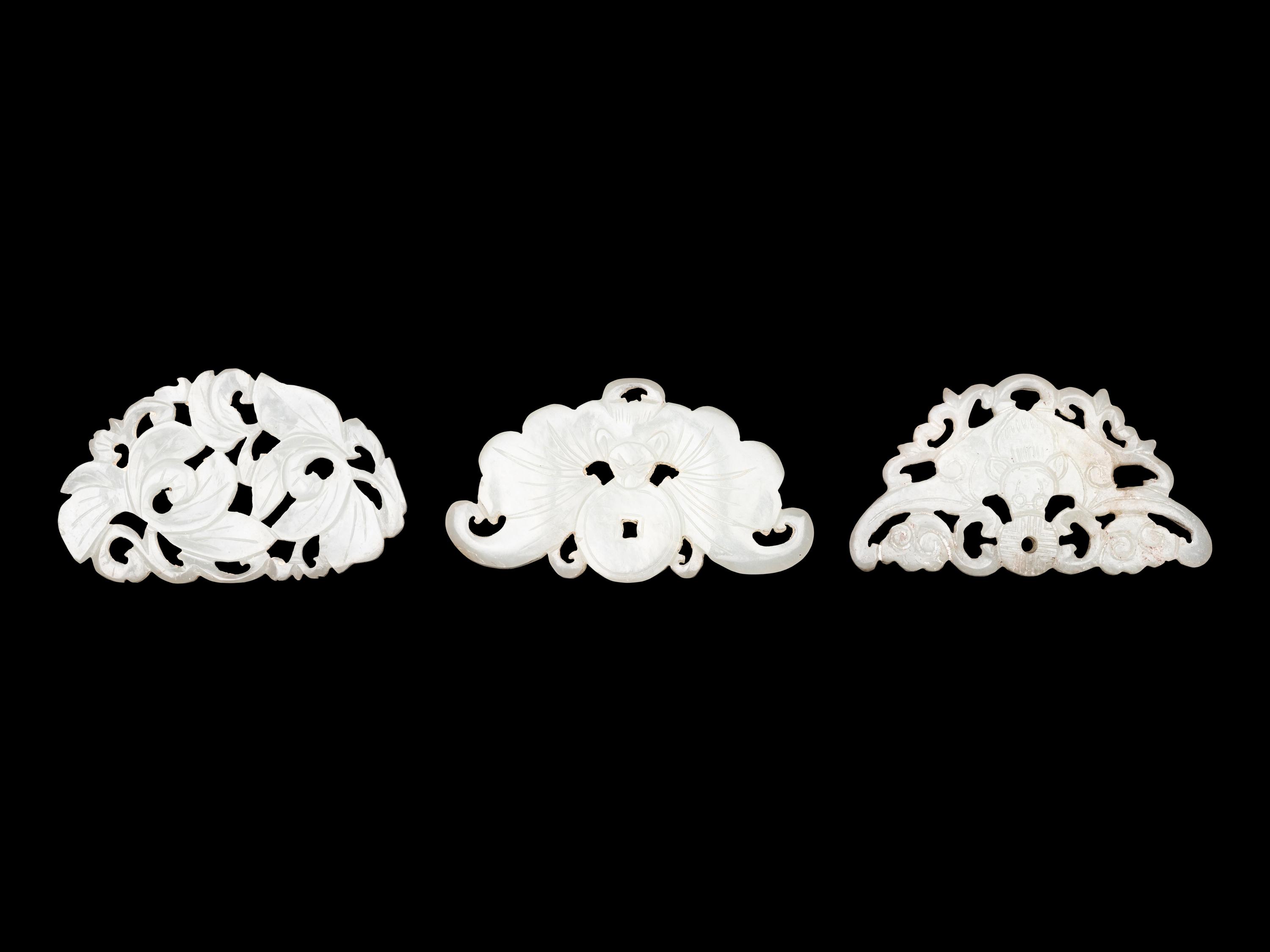 Three Chinese Pale Celadon Jade Reticulated Flori-Form Pendants