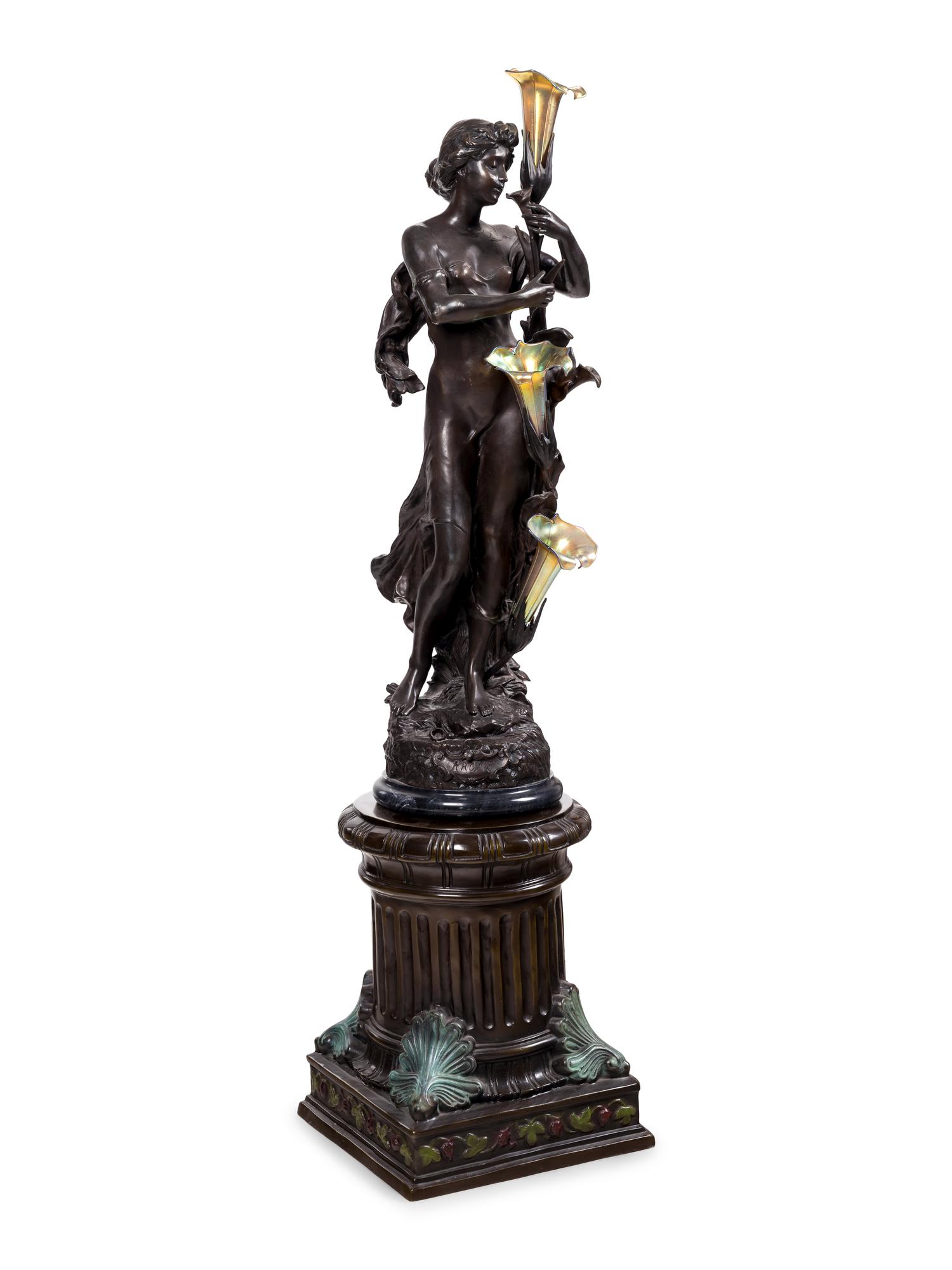 A Patinated Bronze Figural Lamp with Iridescent Glass Shades after Hippolyte François Moreau (French, 1832-1927)