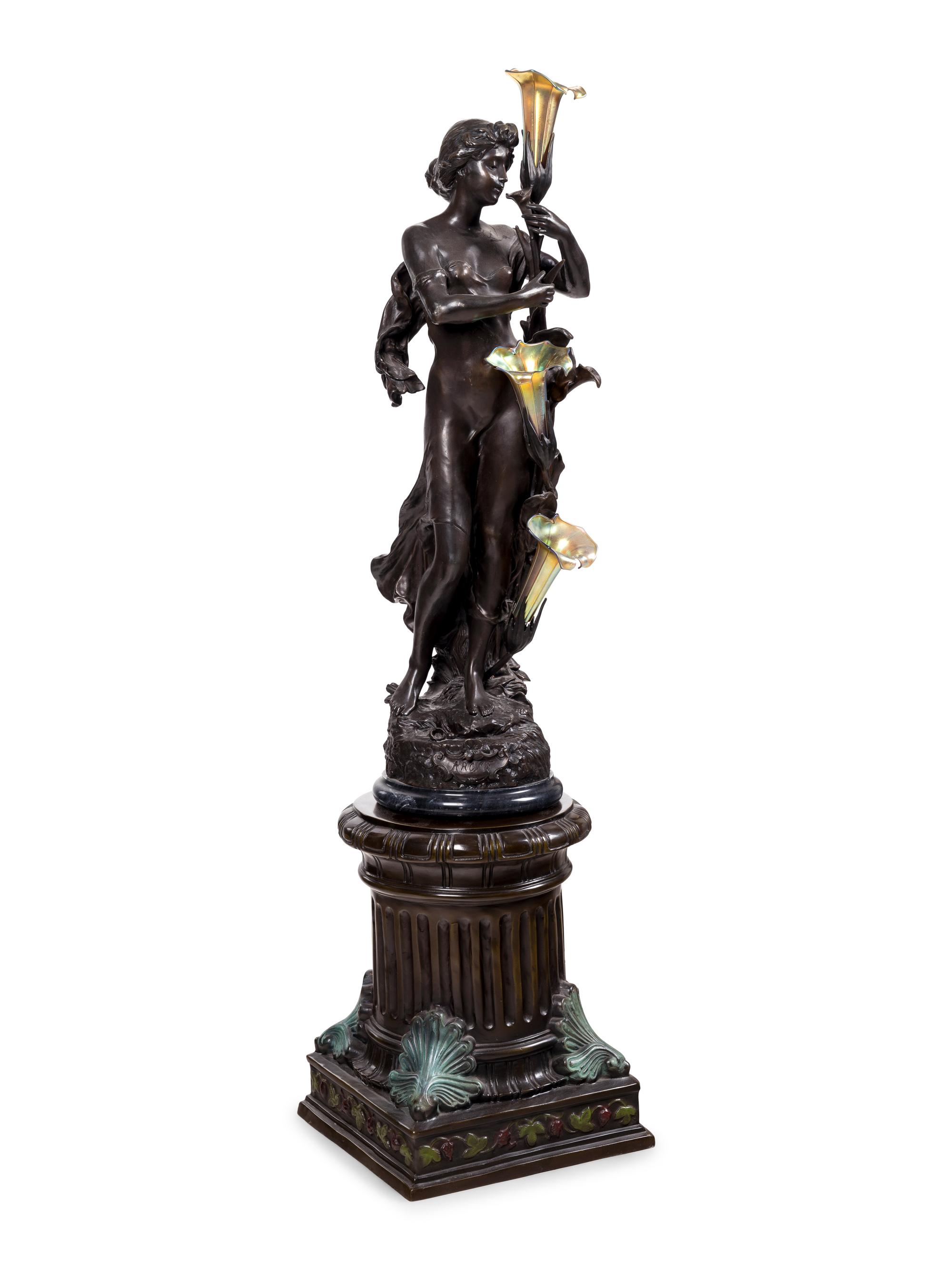A Patinated Bronze Figural Lamp with Iridescent Glass Shades after Hippolyte François Moreau (French, 1832-1927)