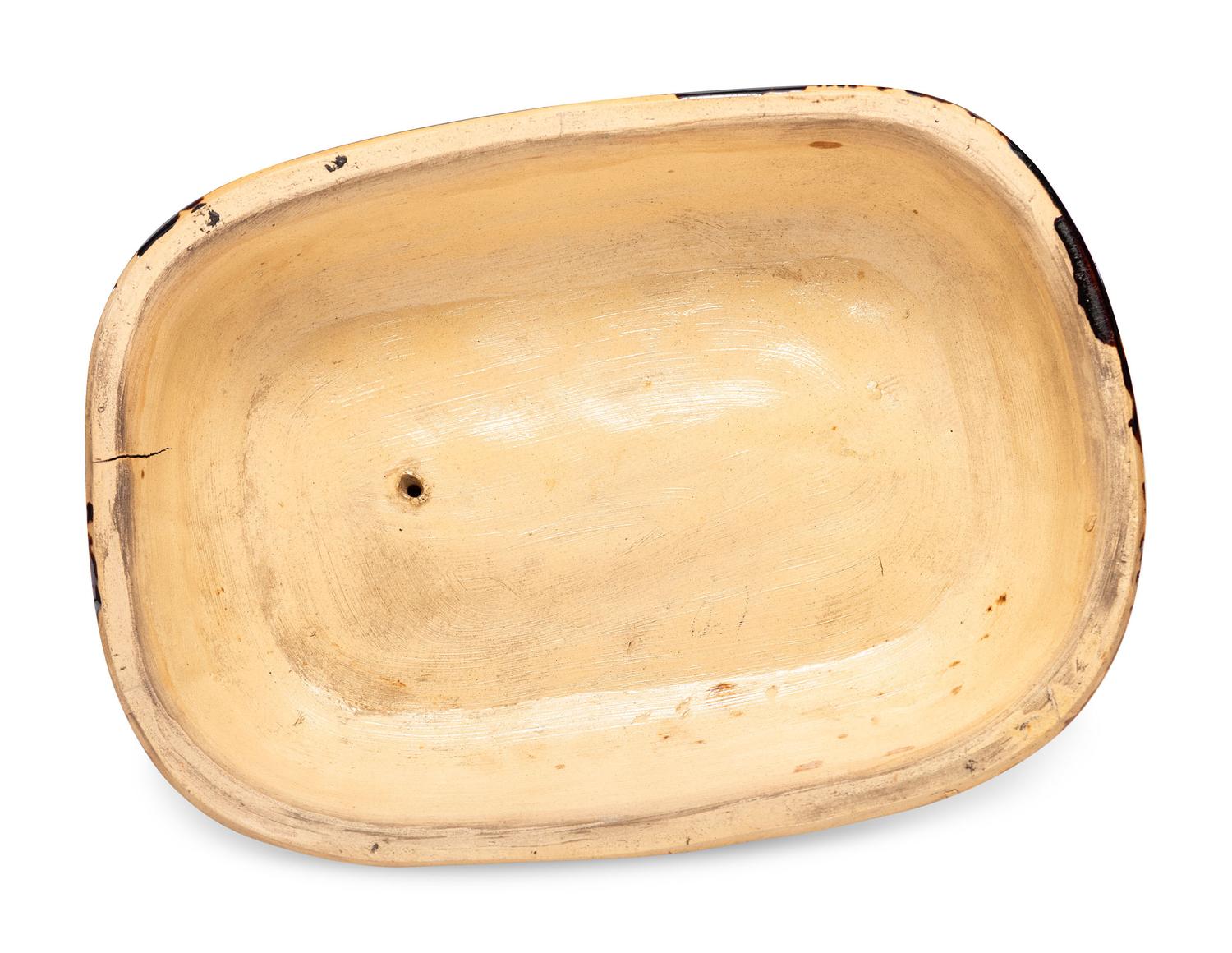 A Rare Rockingham Glazed Molded Yelloware Forward-Facing Dog