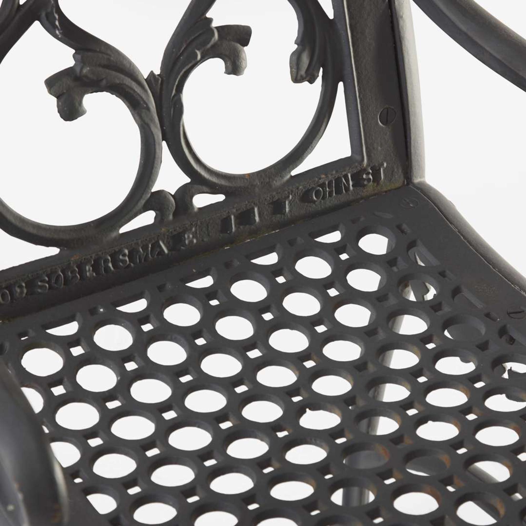 A pair of black-painted cast iron garden armchairs and bench Jacob Sobers, Philadelphia, PA, and John Mclean, New York, NY, late 19th century