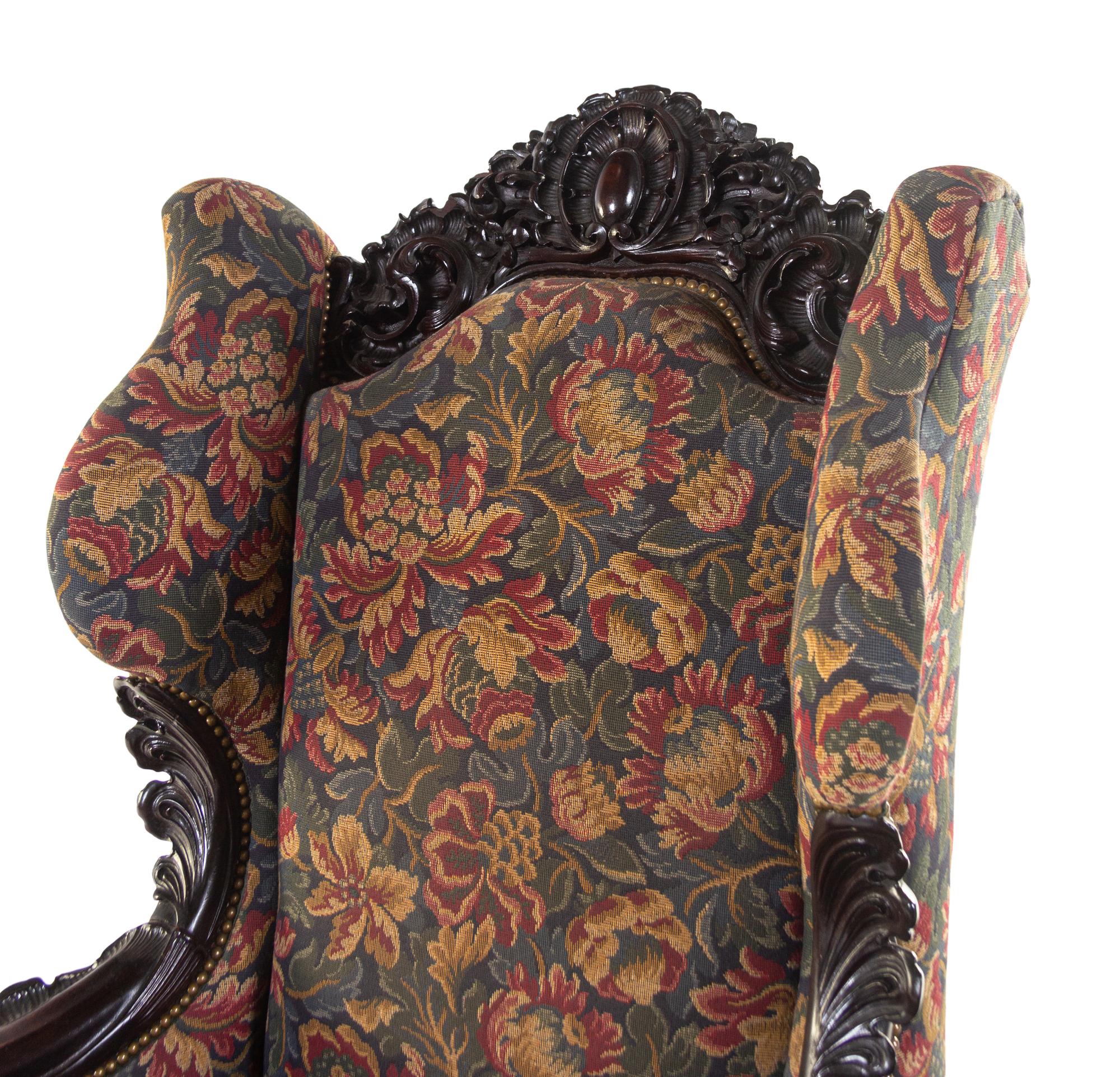 A Karpen Carved Mahogany Wingback Armchair