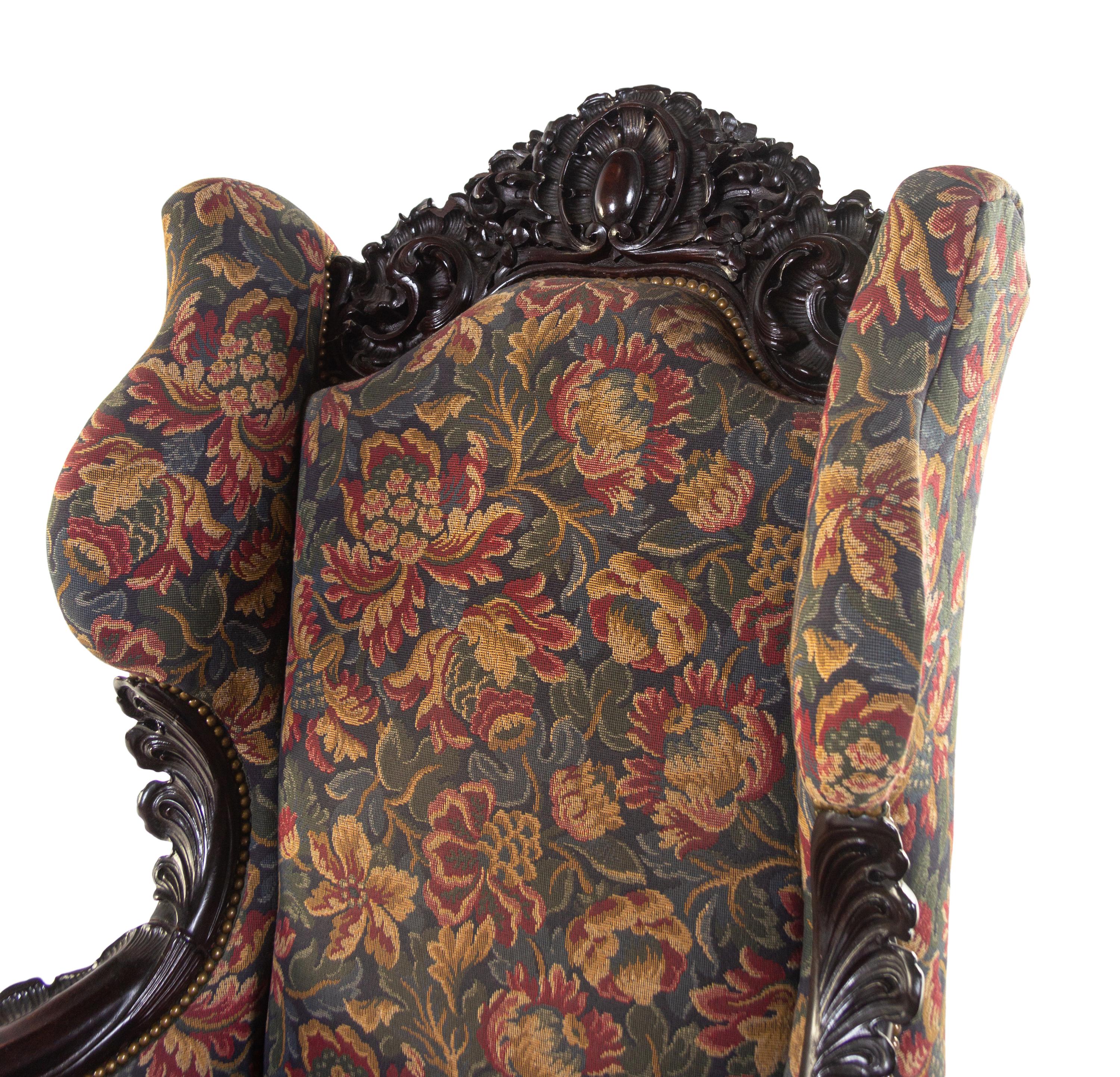 A Karpen Carved Mahogany Wingback Armchair