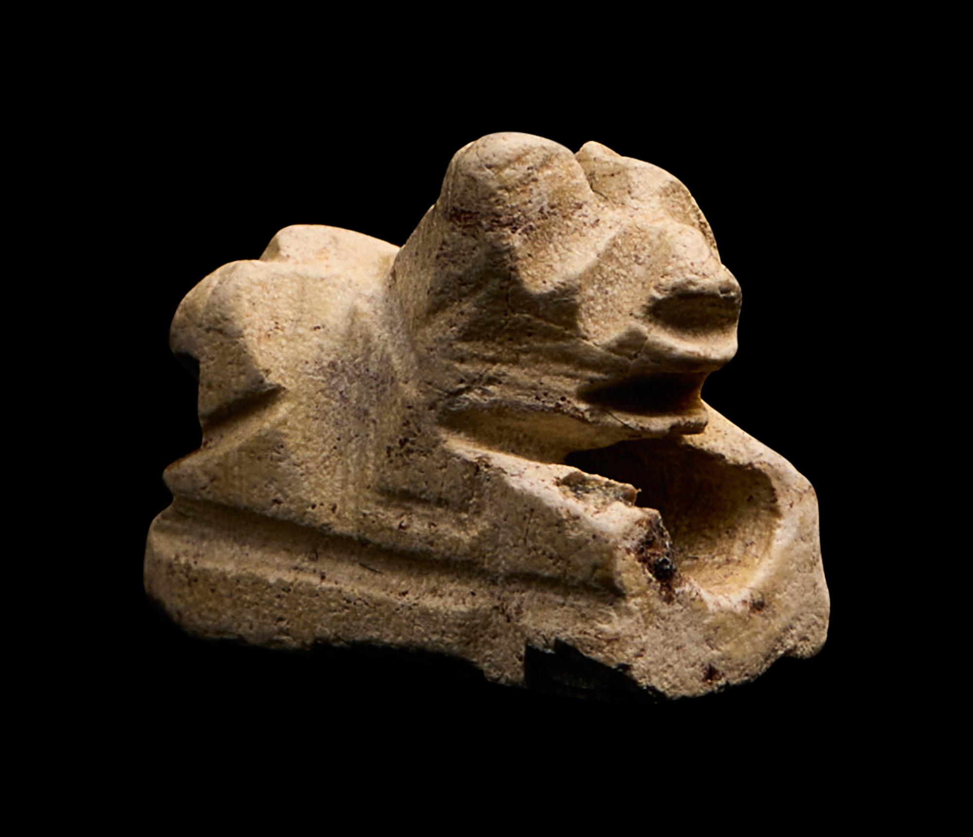 An Egyptian Faience Recumbent Bull or Ram