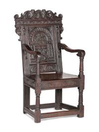 An English Carved Oak and Elm Panel-Back Armchair