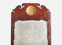 A Queen Anne fret-carved burl walnut and parcel-gilt looking glass, circa 1730-1750