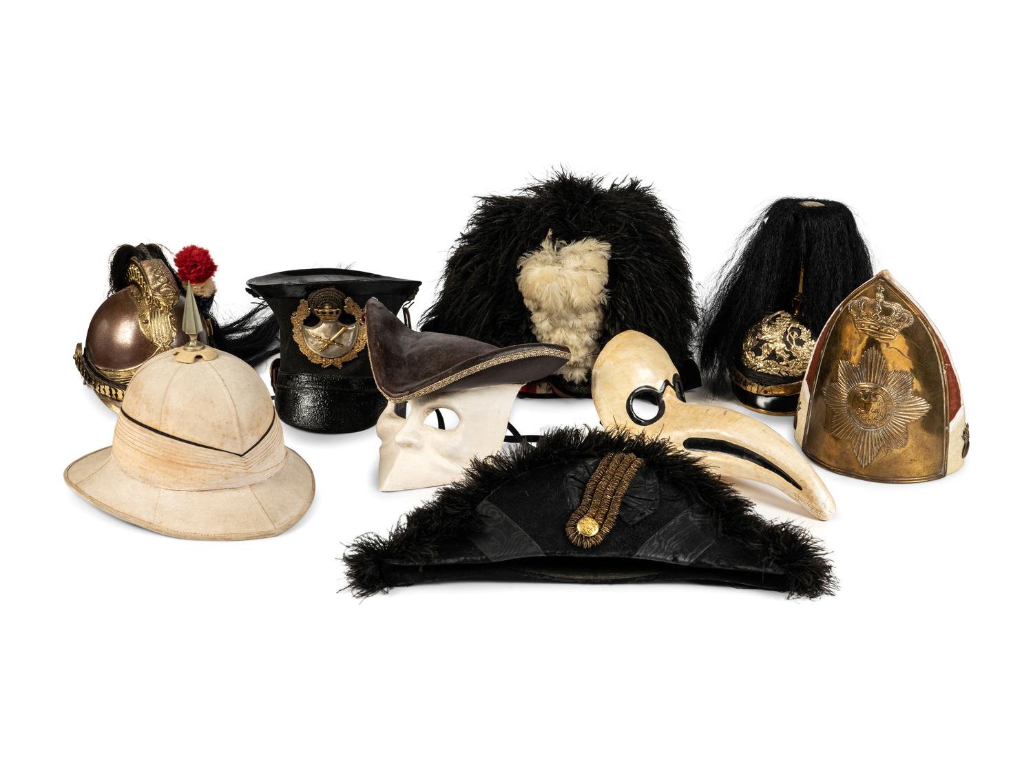 A Collection of Twenty-One Military Parade Helmets, Hats and Masks