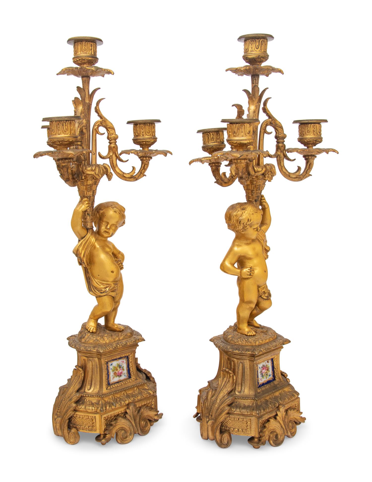 A Pair of French Gilt Bronze and Porcelain Inset Four-Light Candelabra