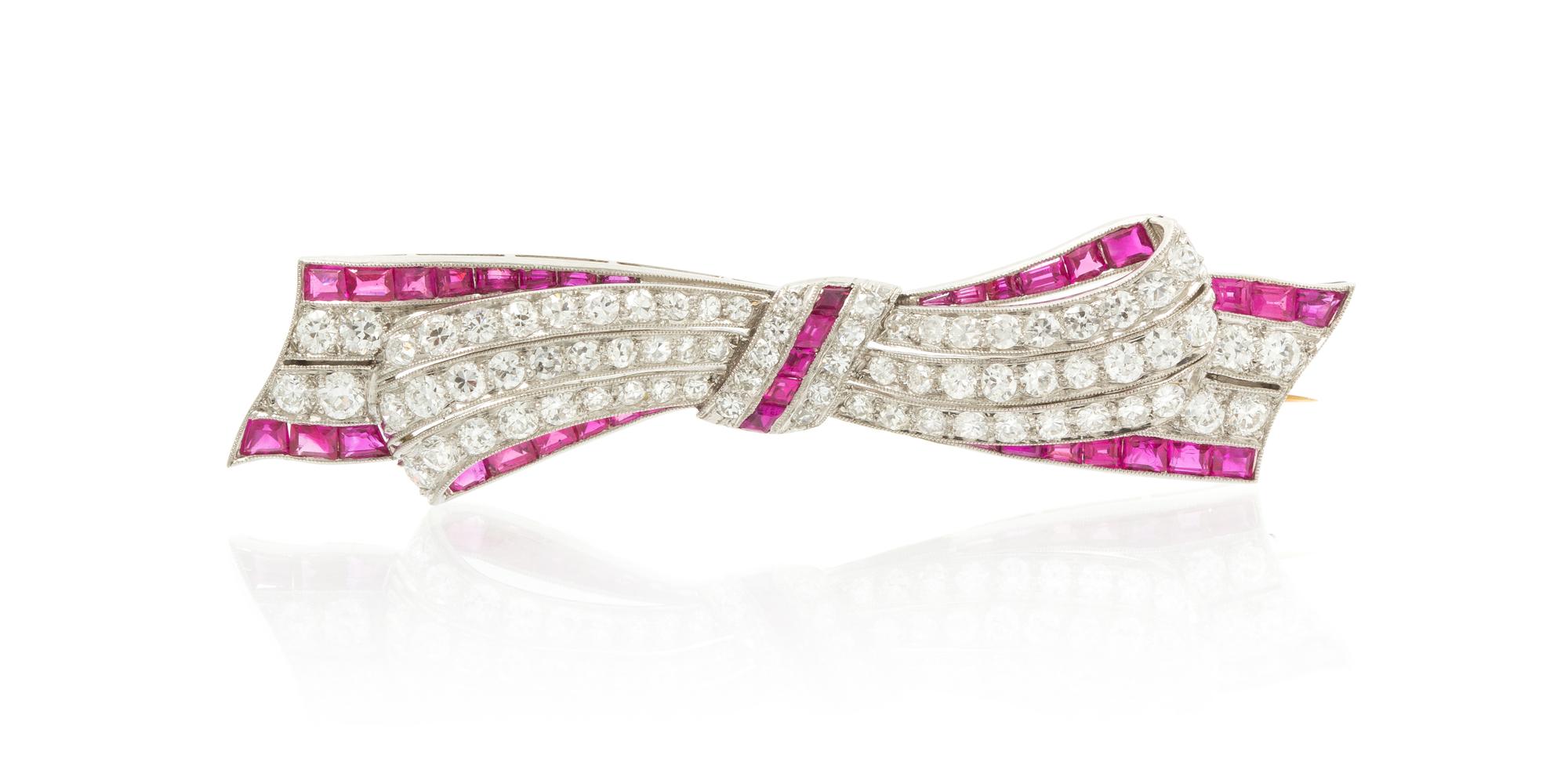 An Art Deco Platinum, Ruby, Synthetic Ruby and Diamond Bow Brooch, 8.20 dwts.