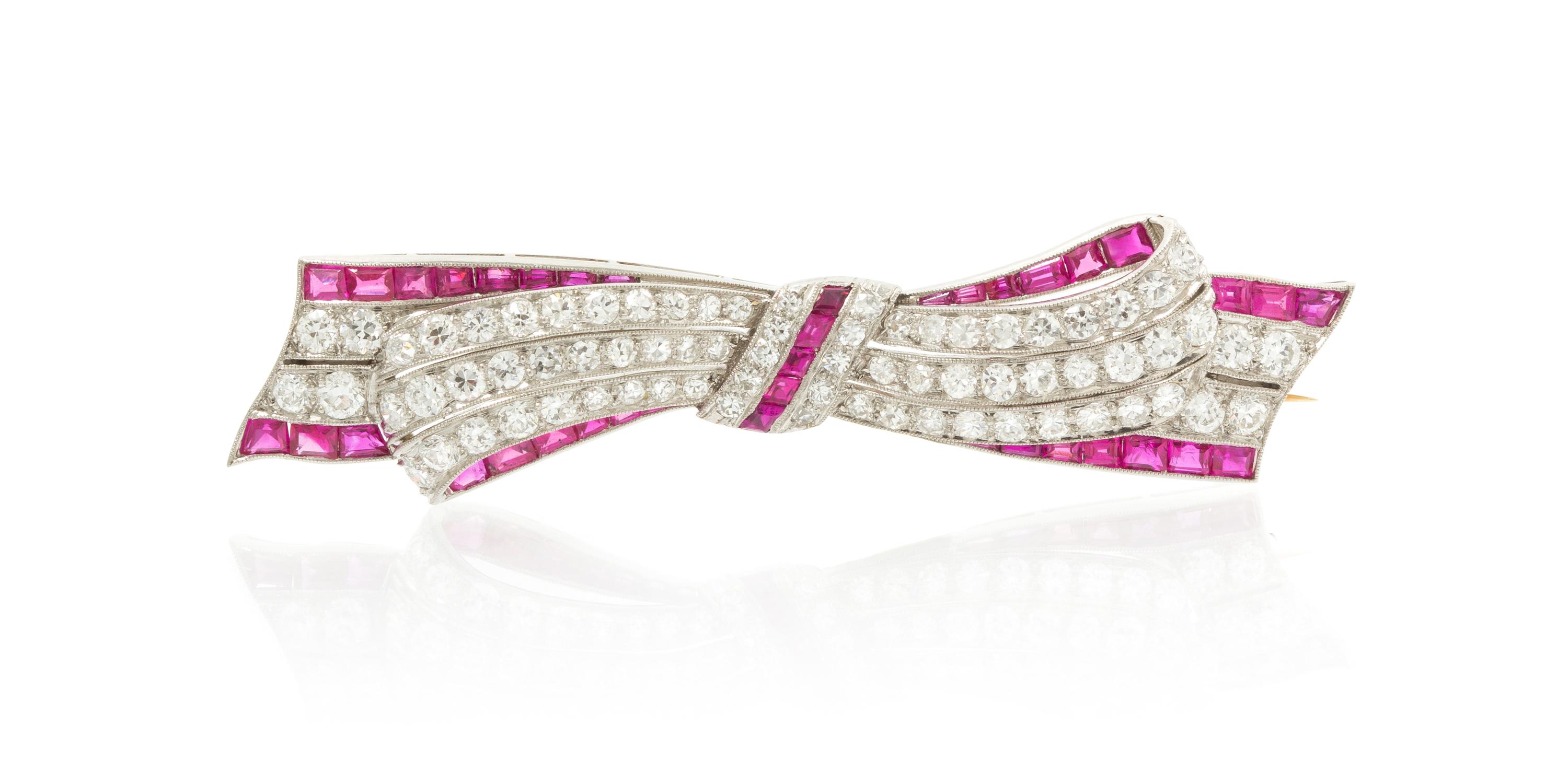An Art Deco Platinum, Ruby, Synthetic Ruby and Diamond Bow Brooch, 8.20 dwts.