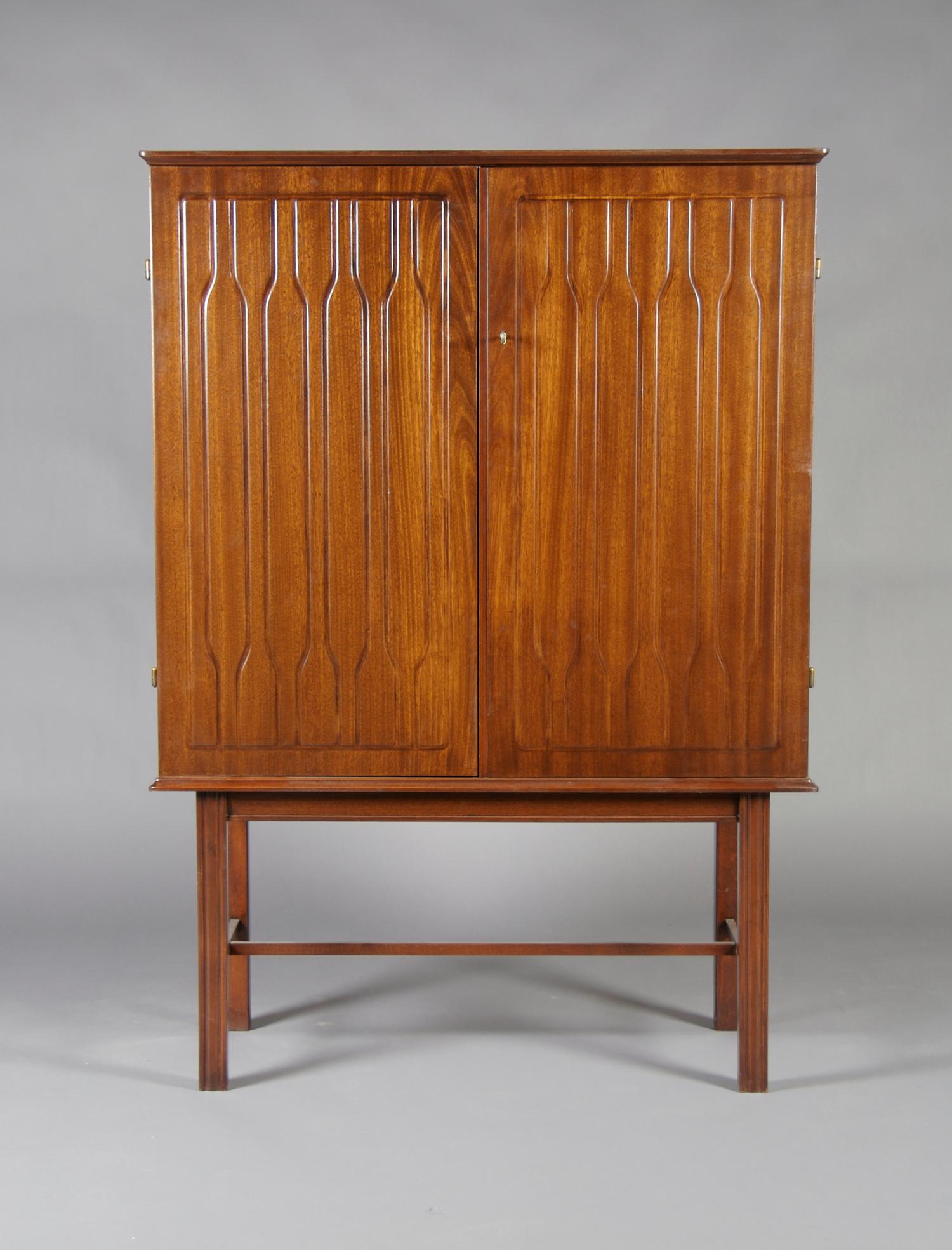 A Swedish Pressed Mahogany Cabinet on Stand, Height 56 3/4 x width 40 1/2 x depth 17 5/16 inches.