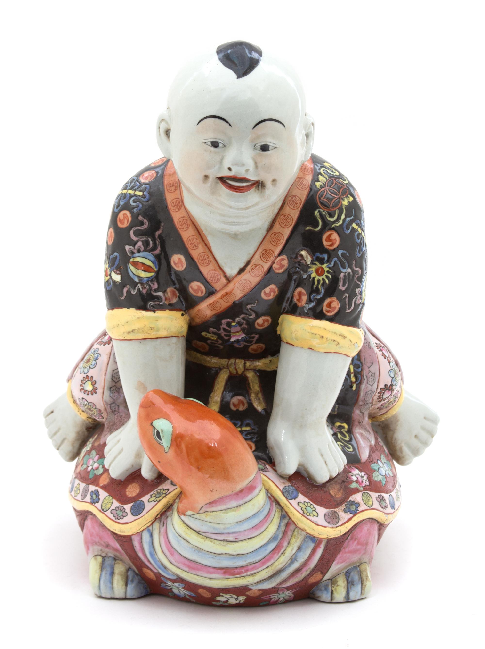 A Chinese Polychromed Porcelain Figure of a Boy Riding a Turtle Height 15 inches. — LATE 19TH/EARLY 20TH CENTURY