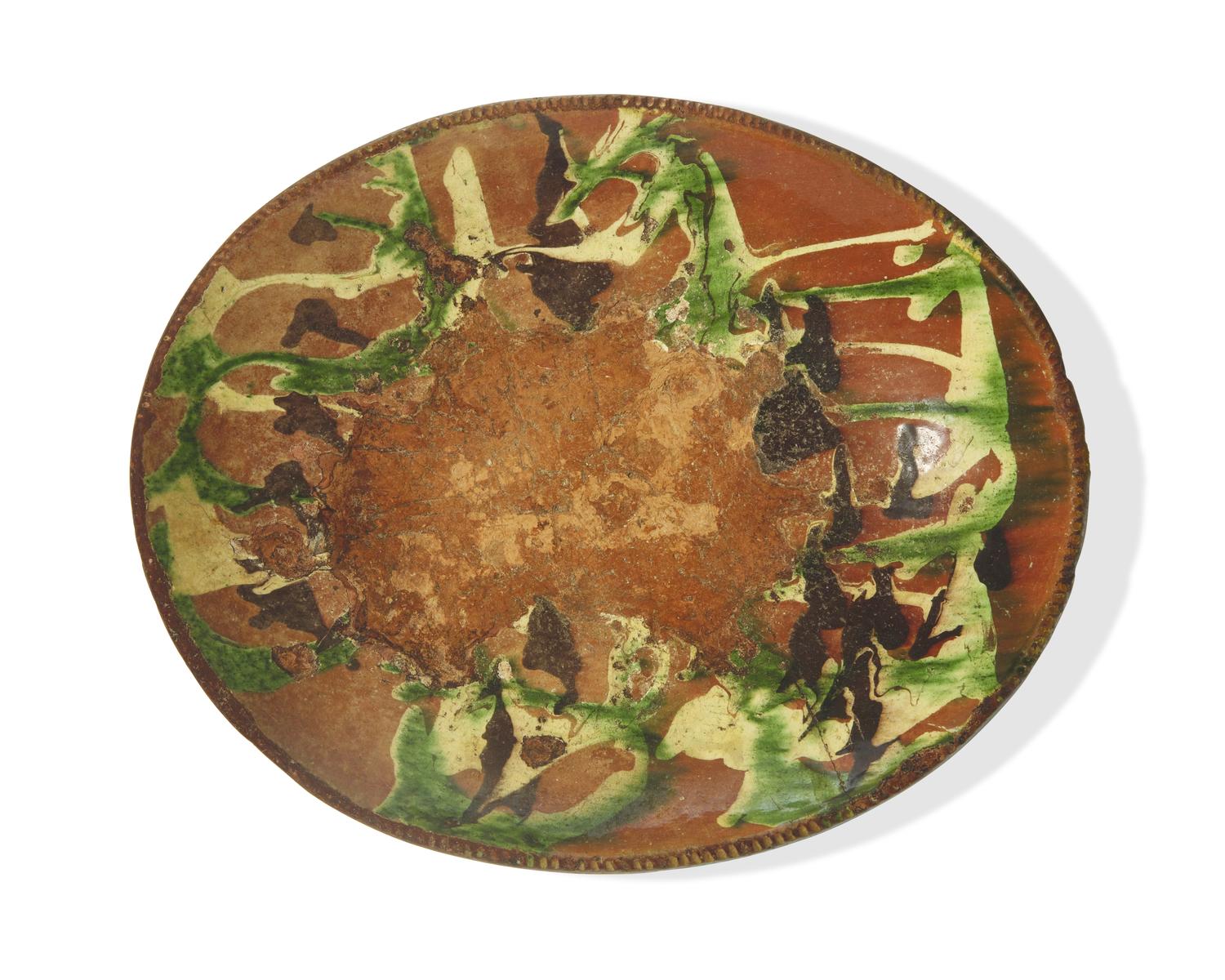 A Large Oval Slip-Decorated Redware Dish, Pennsylvania, Late 18th Century