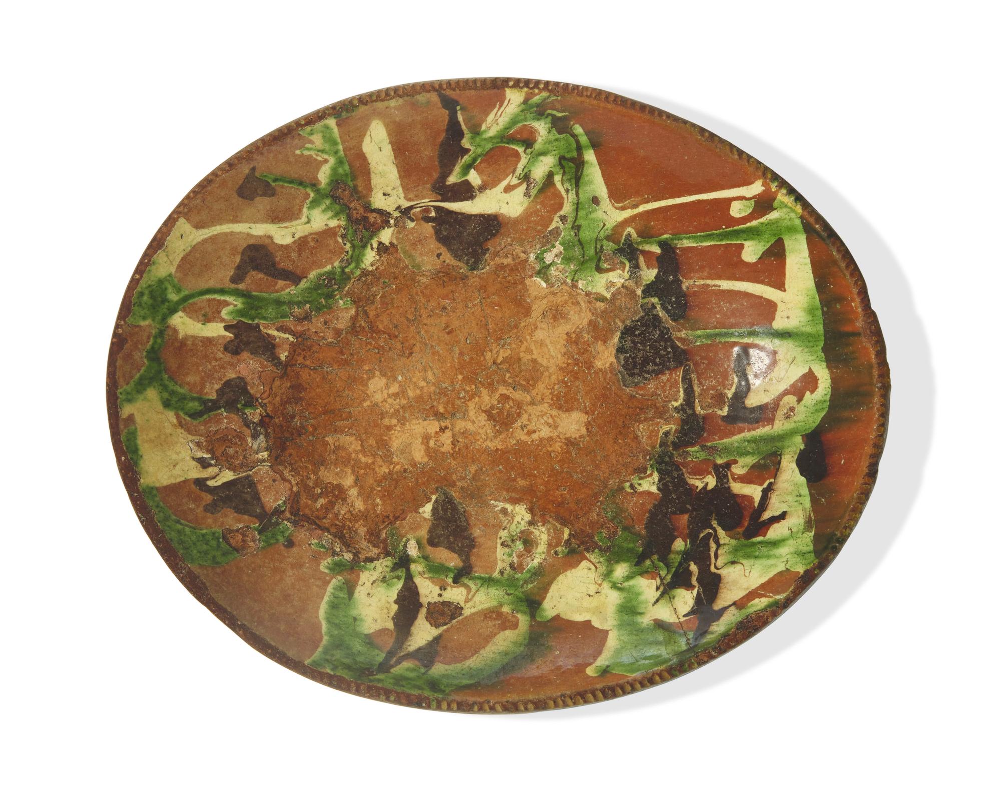 A Large Oval Slip-Decorated Redware Dish, Pennsylvania, Late 18th Century