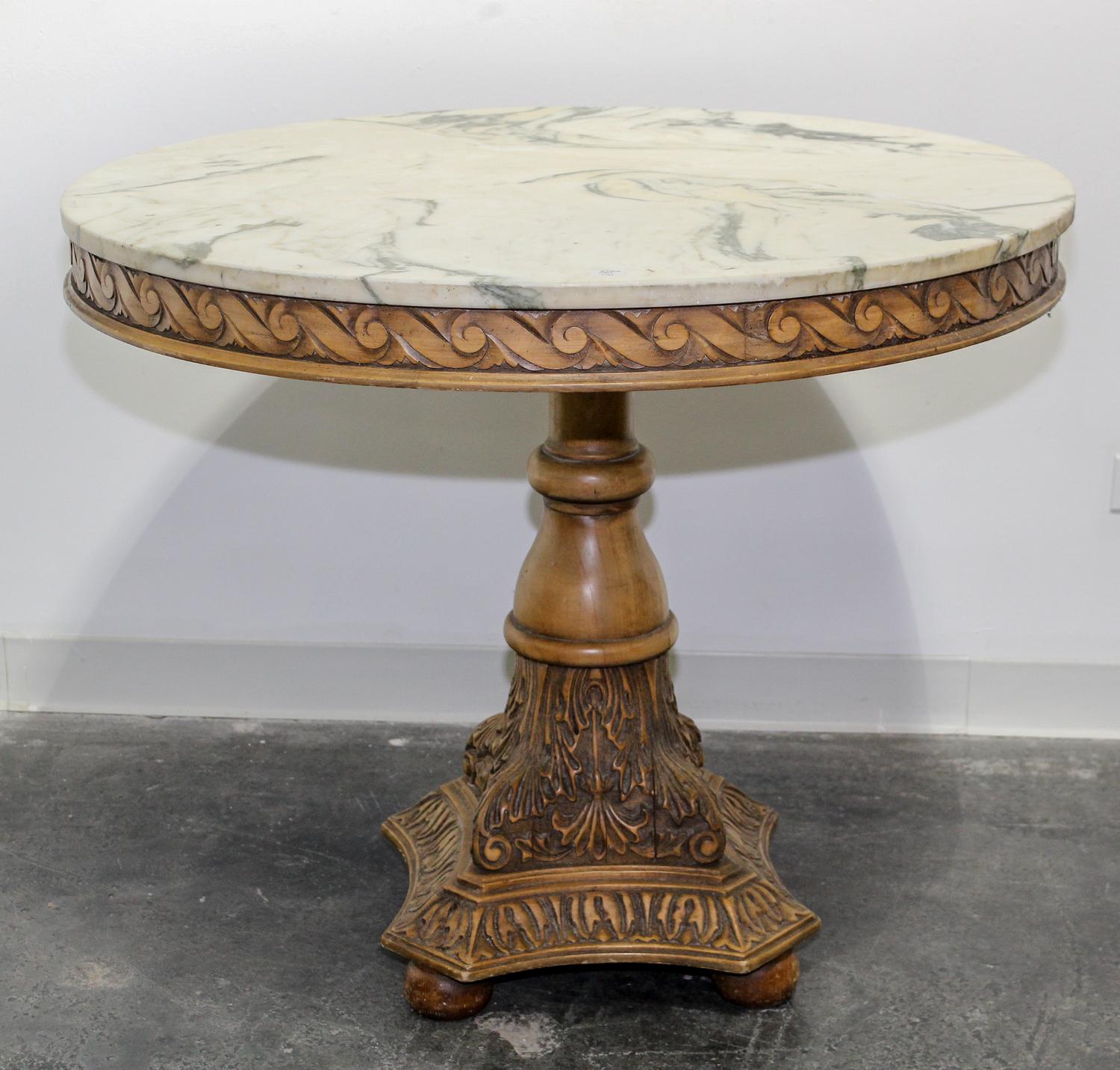 A Neoclassical Style Carved Breakfast Table Height 31 x diameter of top 36 inches. — 20TH CENTURY