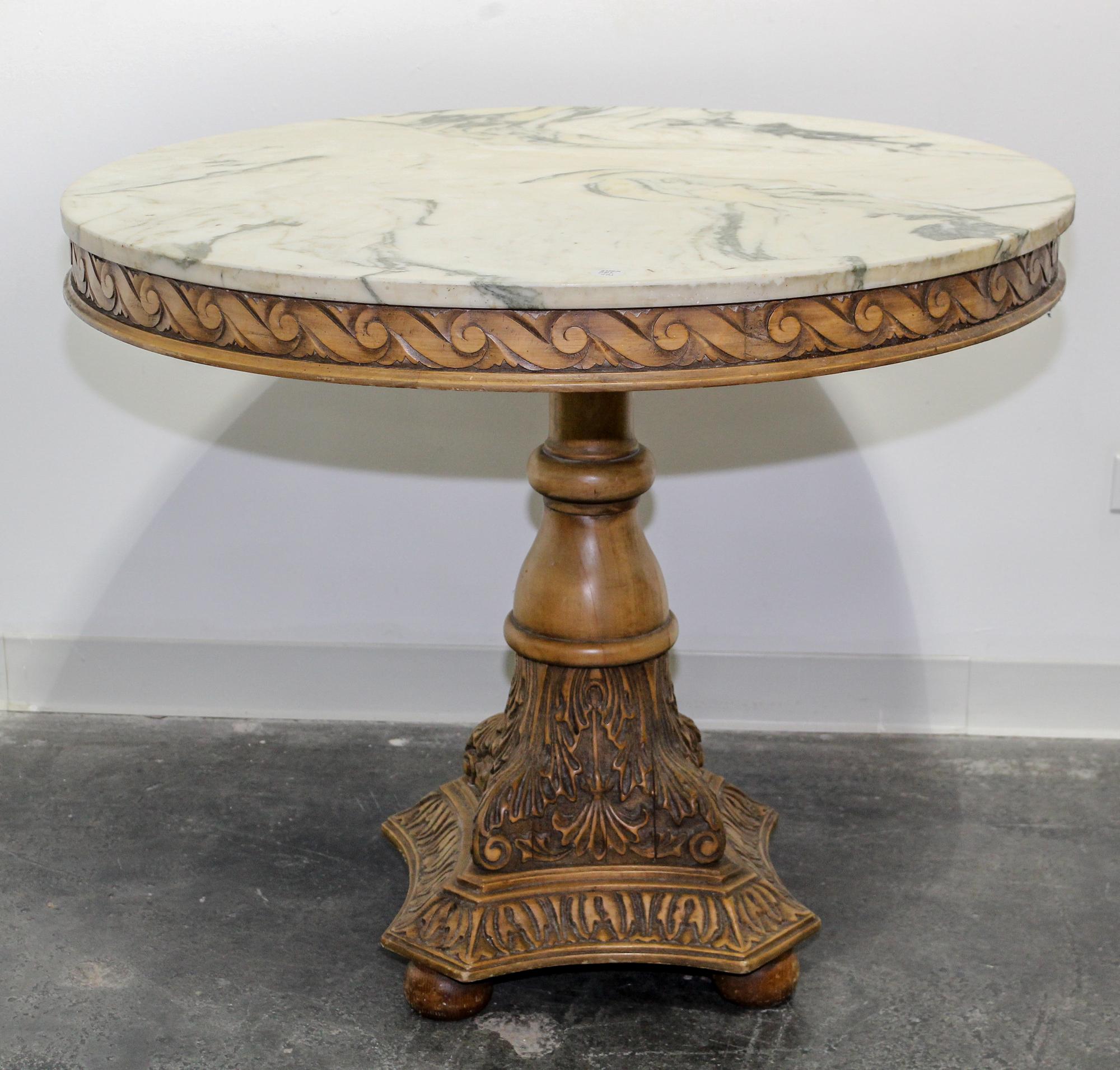 A Neoclassical Style Carved Breakfast Table Height 31 x diameter of top 36 inches. — 20TH CENTURY