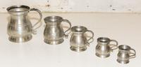 A Set of Five Pewter Jugs. Height of tallest 4 7/8 inches.