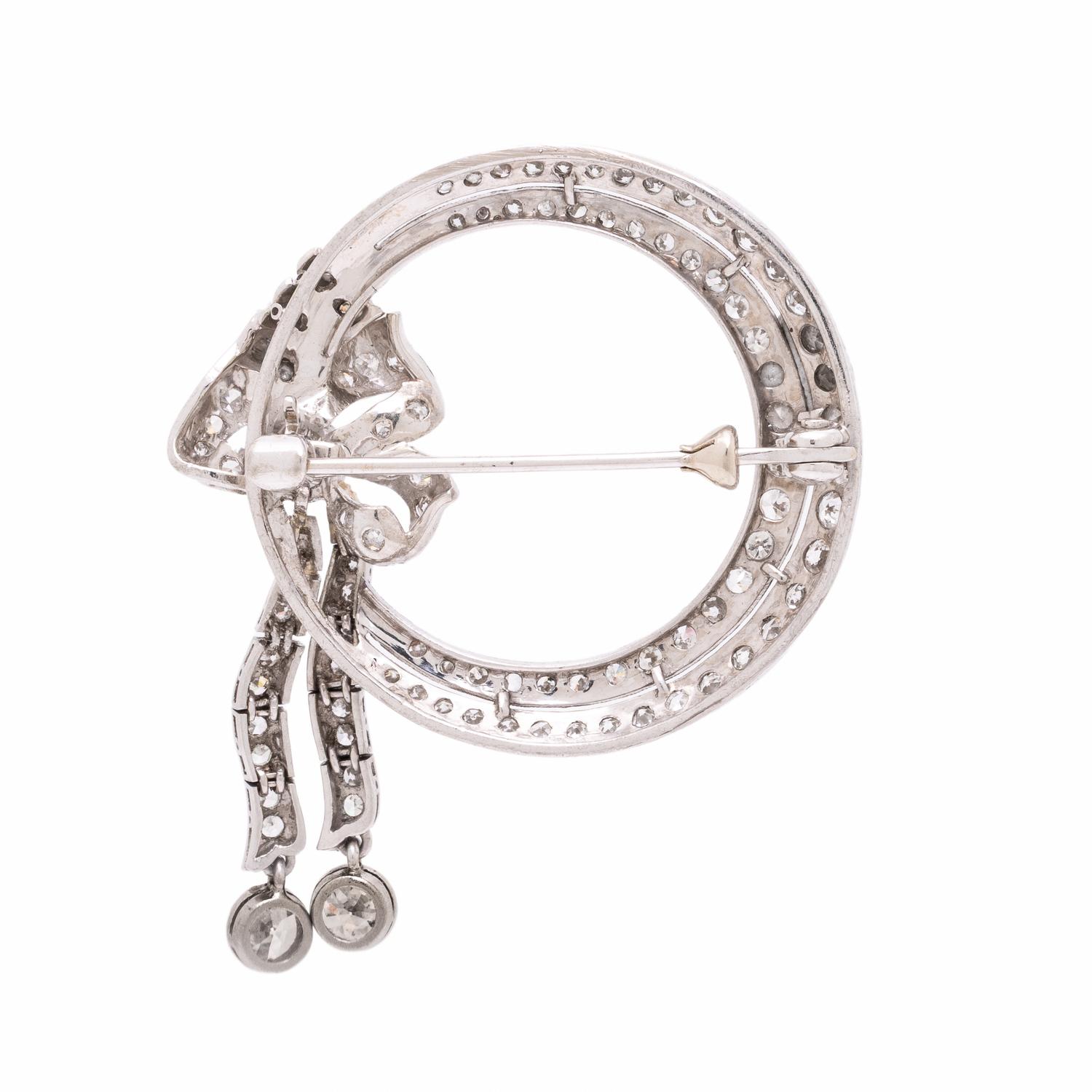 Diamond and Platinum Circle Brooch with Articulated Bow