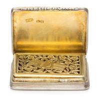 A Silver Vinaigrette, With spurious Georgian marks, having an engine turned decorated case centered by a vacant cartouche.