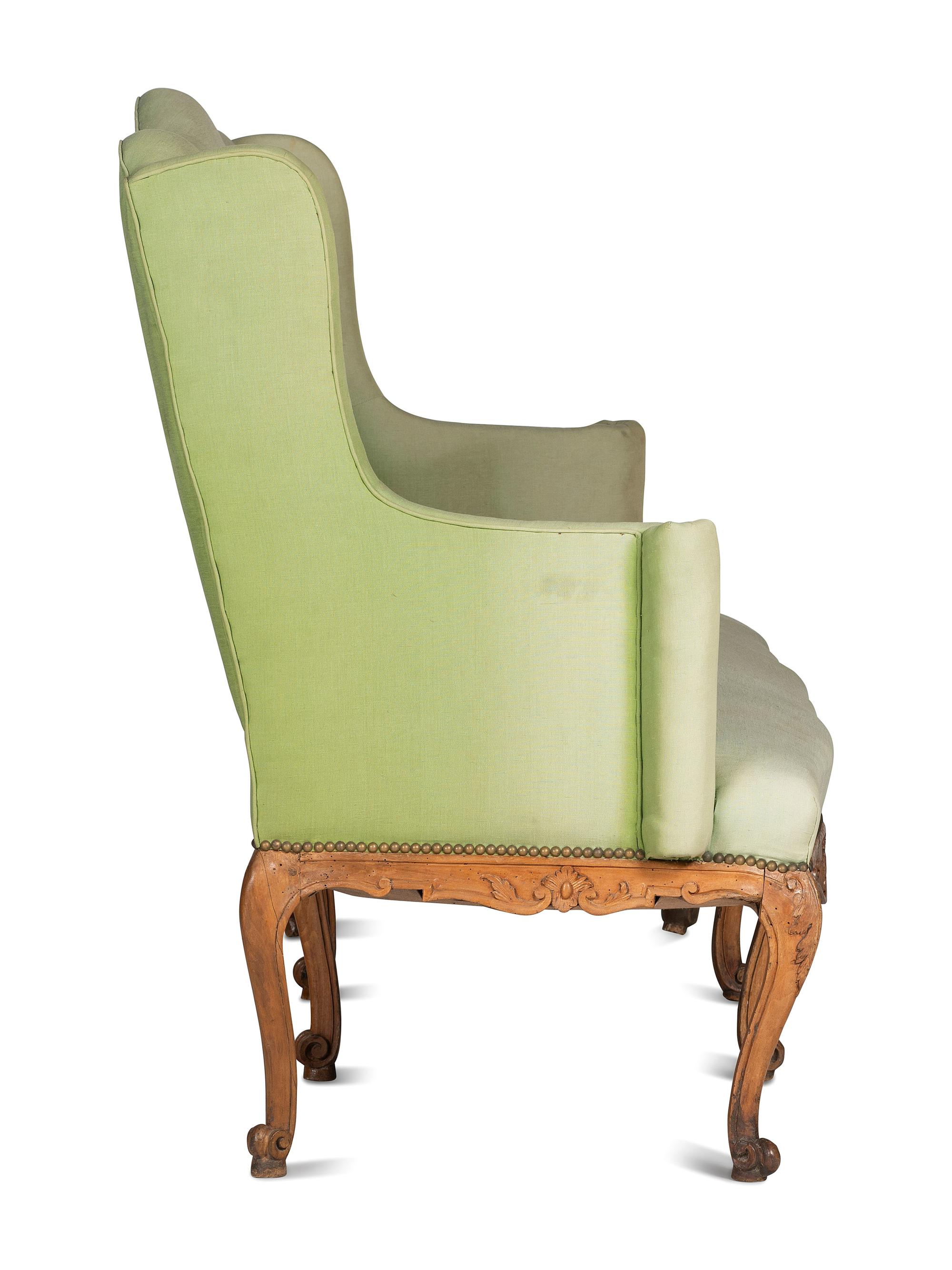 A French Provincial Carved Fruitwood Upholstered High-Back Sofa