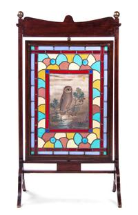 An Aesthetic Walnut, Leaded and Stained Glass Fire Screen, Height 46 3/4 x width 25 x depth 15 1/4 inches.