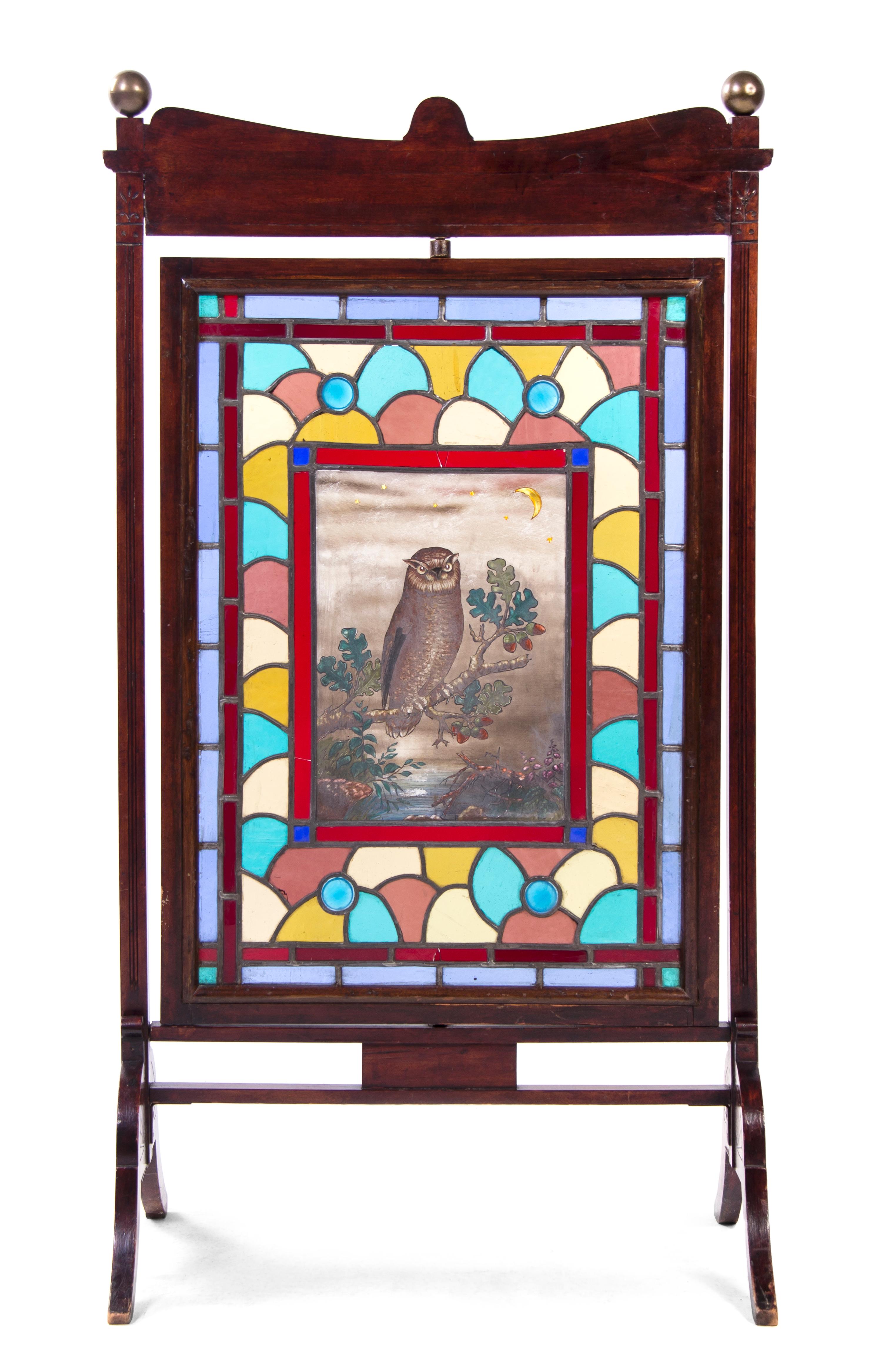 An Aesthetic Walnut, Leaded and Stained Glass Fire Screen, Height 46 3/4 x width 25 x depth 15 1/4 inches.