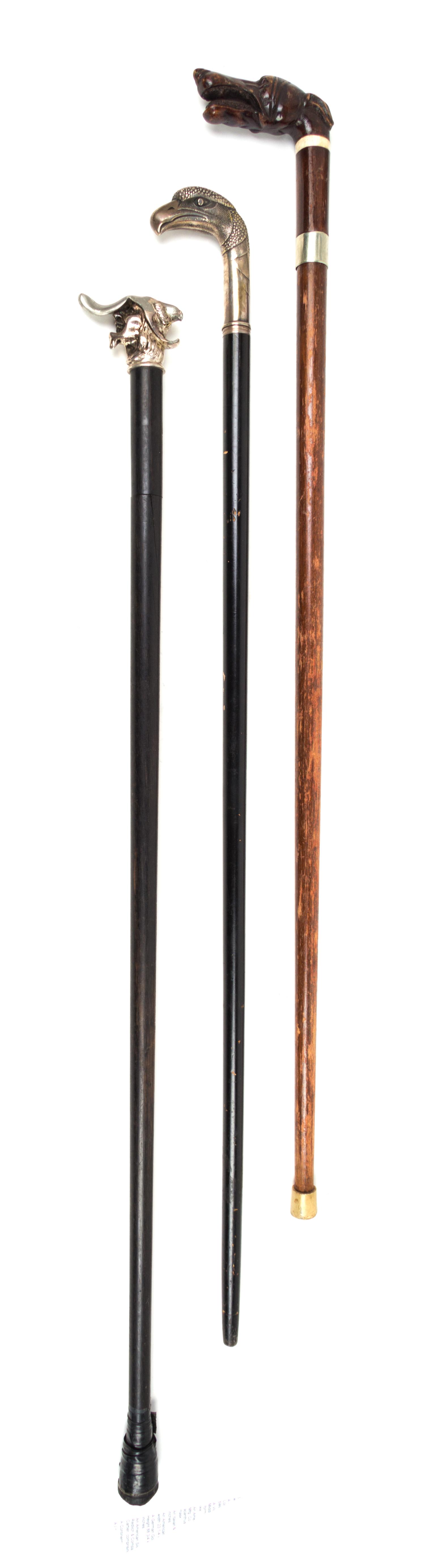 Three Figural Handled Sword Canes Length of longest 37 5/8 inches.