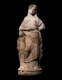 A Greek Terracotta Standing Draped Female Deity