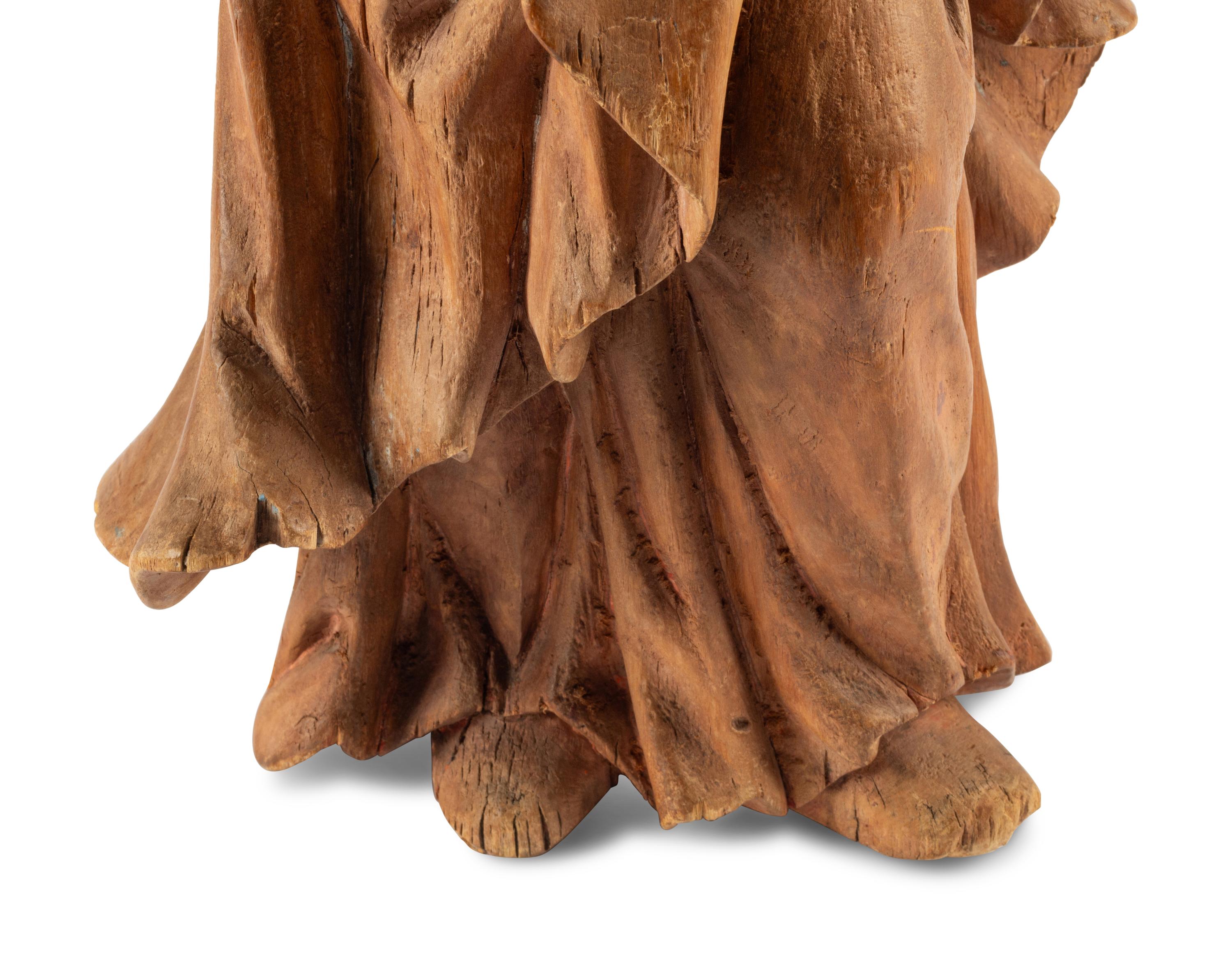 A Continental Carved Fruitwood Saint Figure