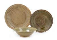 Three Thai Celadon Glazed Porcelain Chargers Diameter of largest 14 inches. — 15TH/16TH CENTURY