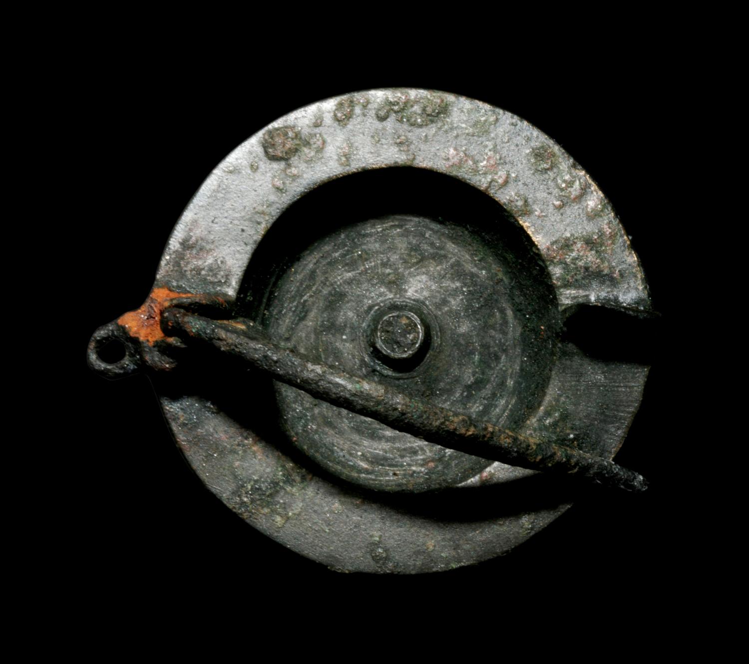 A Romano-Celtic Bronze and Blue Glass Fibula with a Mask