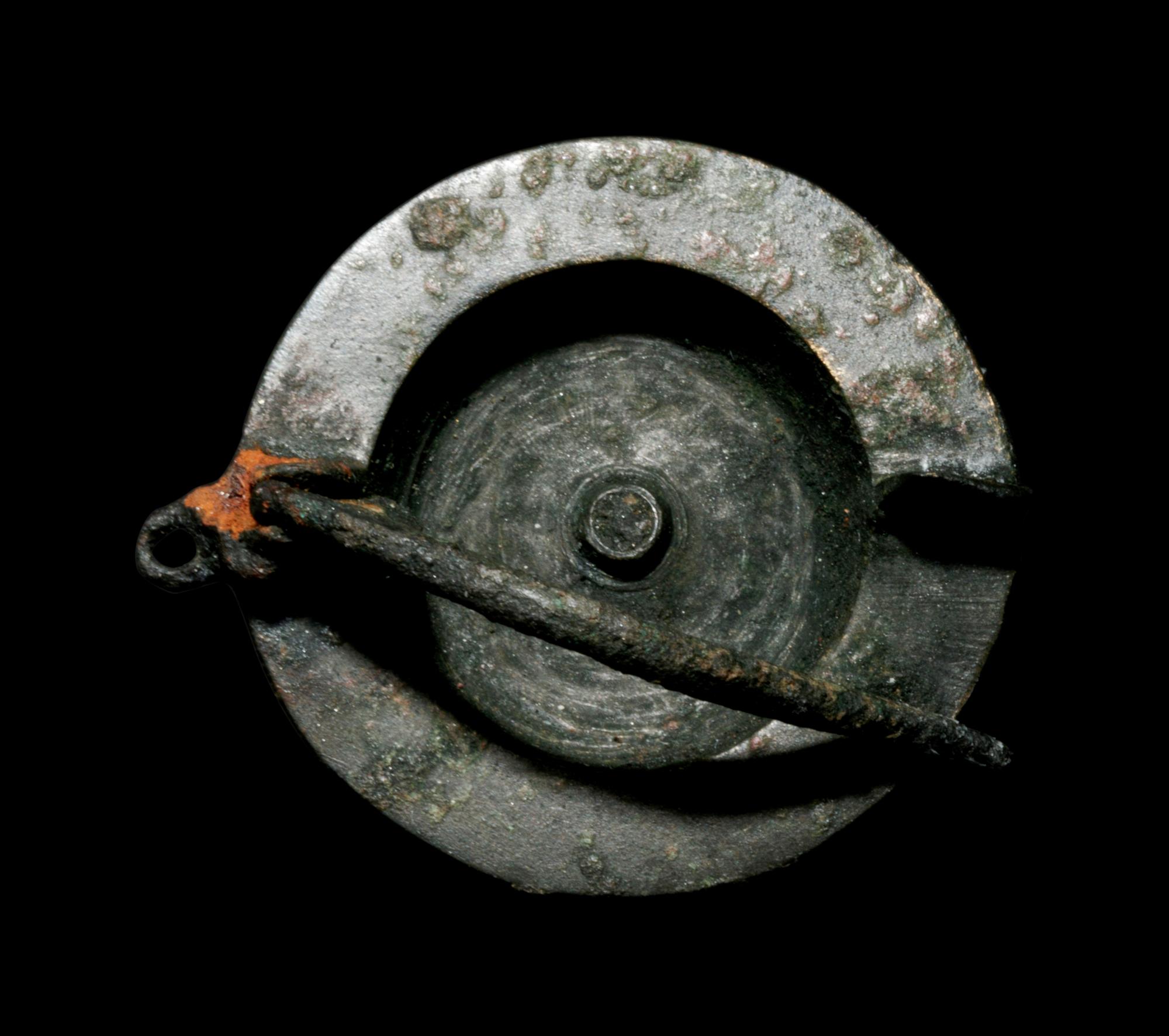 A Romano-Celtic Bronze and Blue Glass Fibula with a Mask