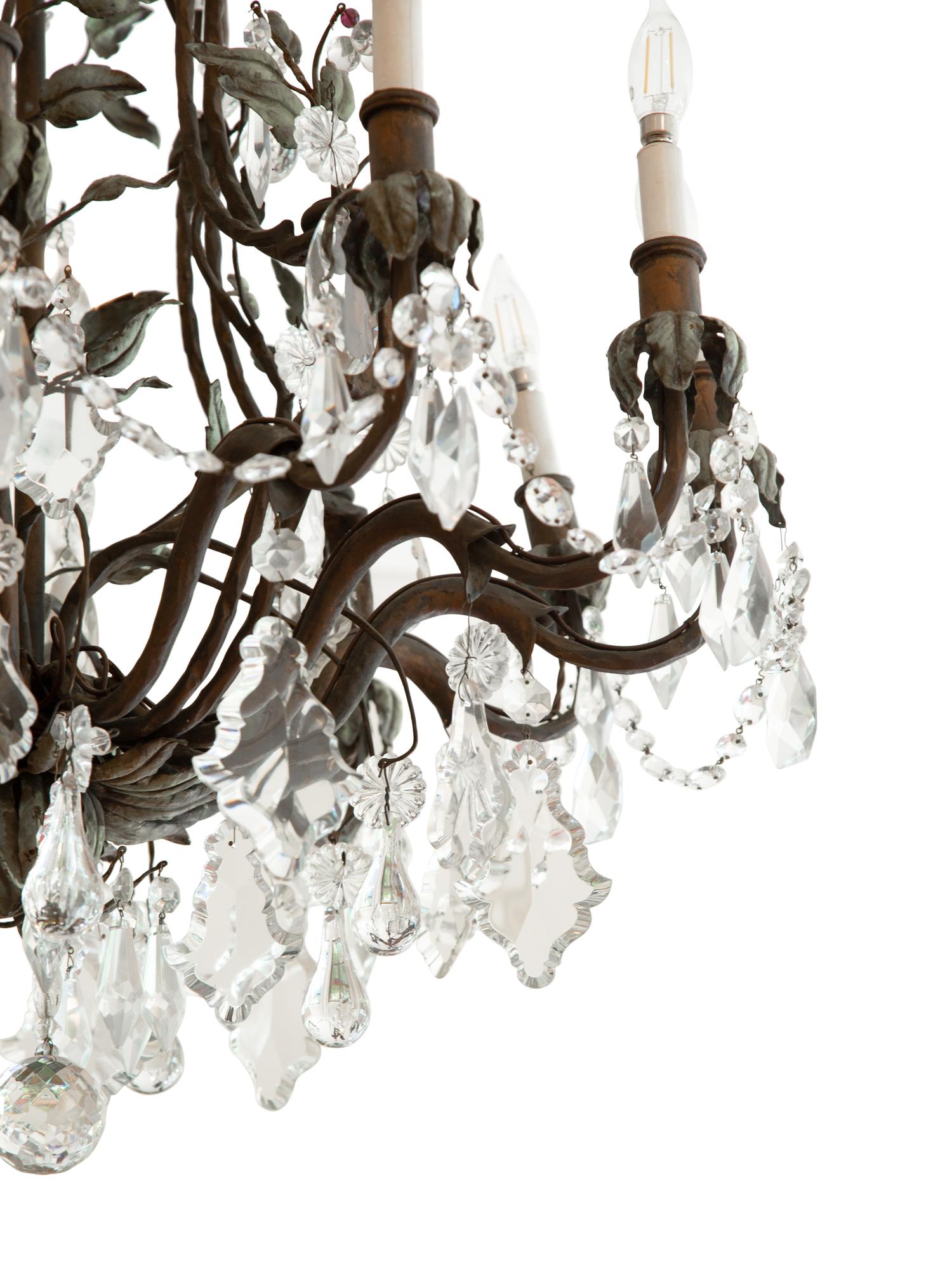 A Continental Patinated Bronze, Tole and Cut Glass Twelve-Light Chandelier