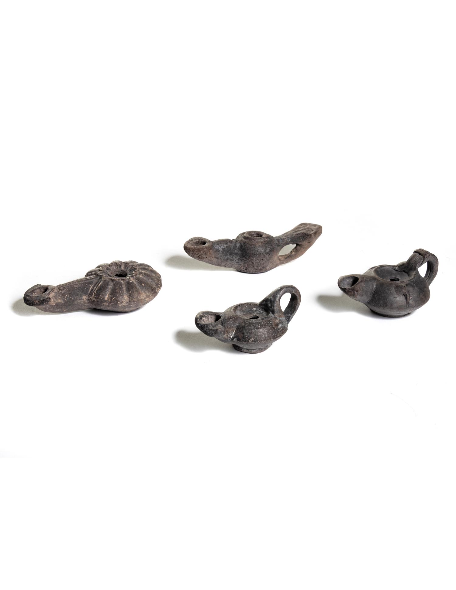 Four Roman Molded Terra Cotta Oil Lamps