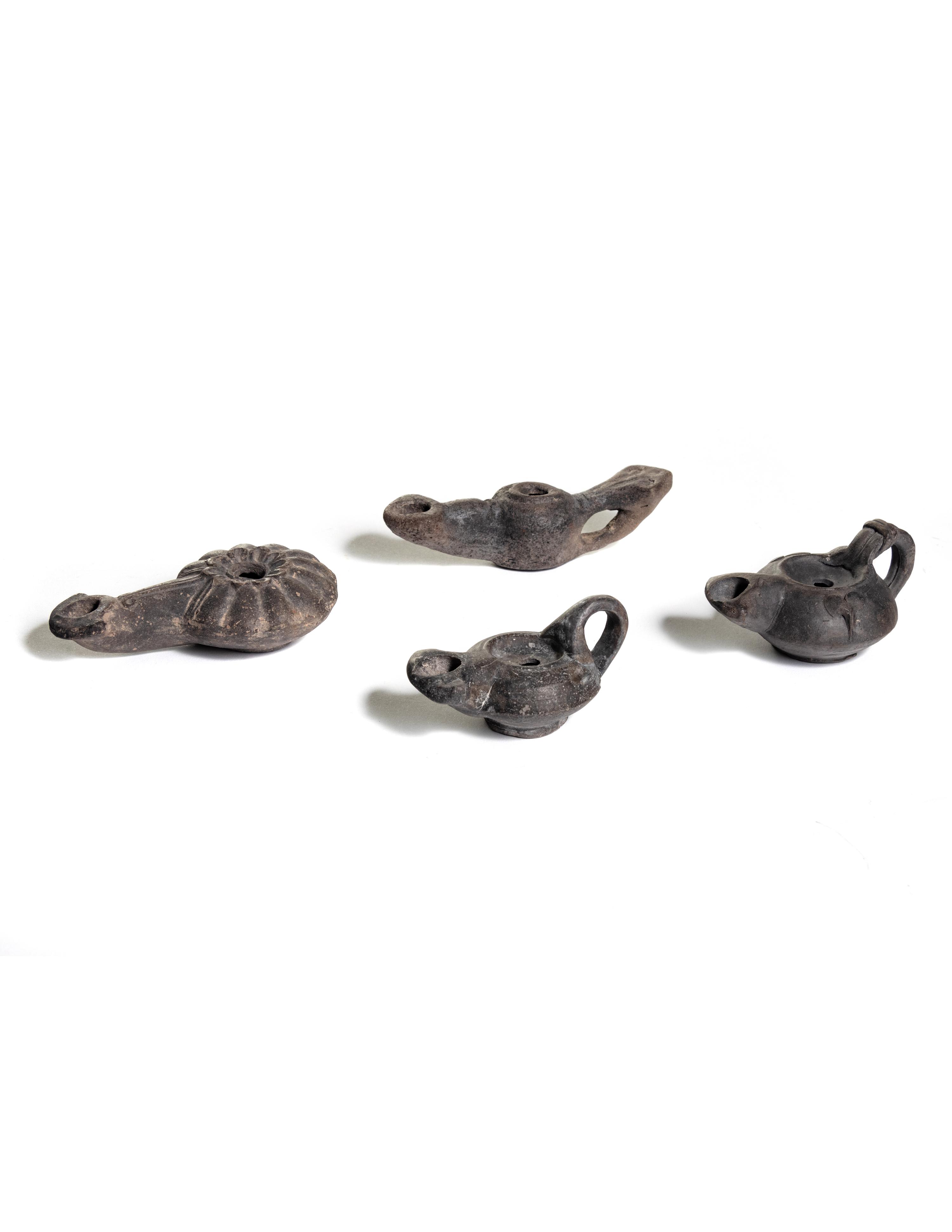 Four Roman Molded Terra Cotta Oil Lamps