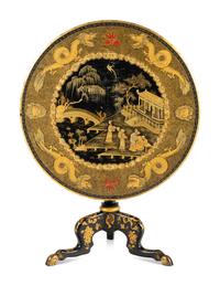 A Regency Style Lacquered and Gilt Decorated Tilt Top Tea Table