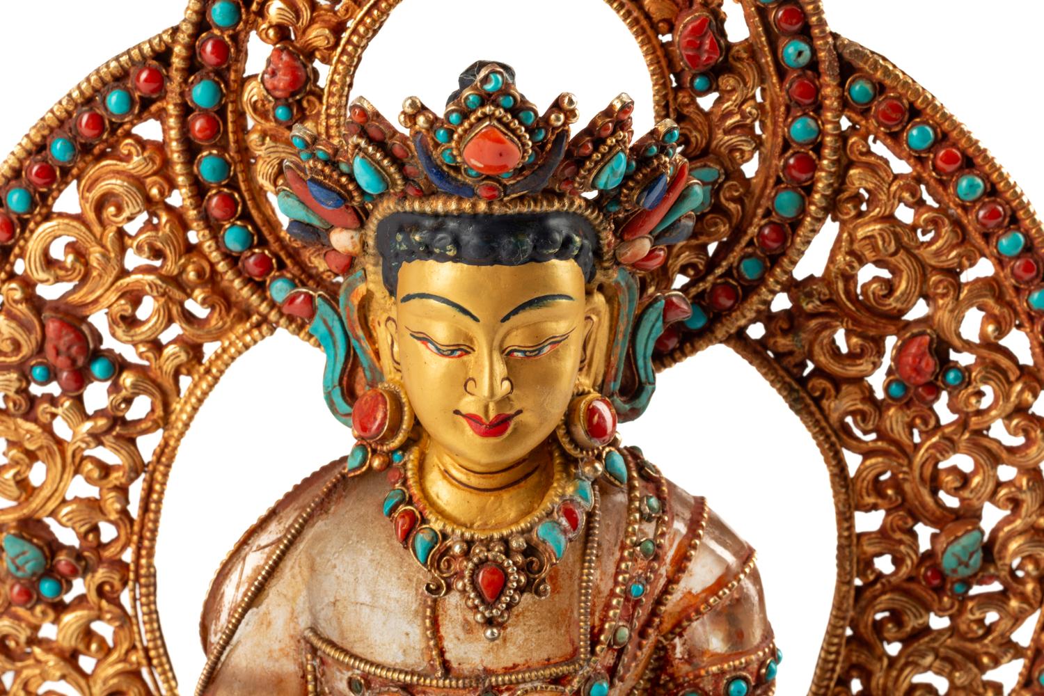 A Tibetan Style Rock Crystal, Gilt Metal Filigree, Turquoise and Carnelian Deity