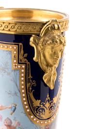 A Pair of Sèvres Style Gilt Bronze Mounted Painted, Parcel Gilt and "Jeweled" Porcelain Urns