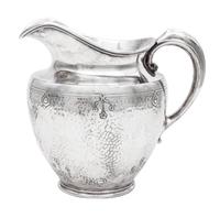 An American Arts and Crafts Silver-Plate Water Pitcher, Reed & Barton, Taunton, MA, having a spot-hammered body decorated with incised