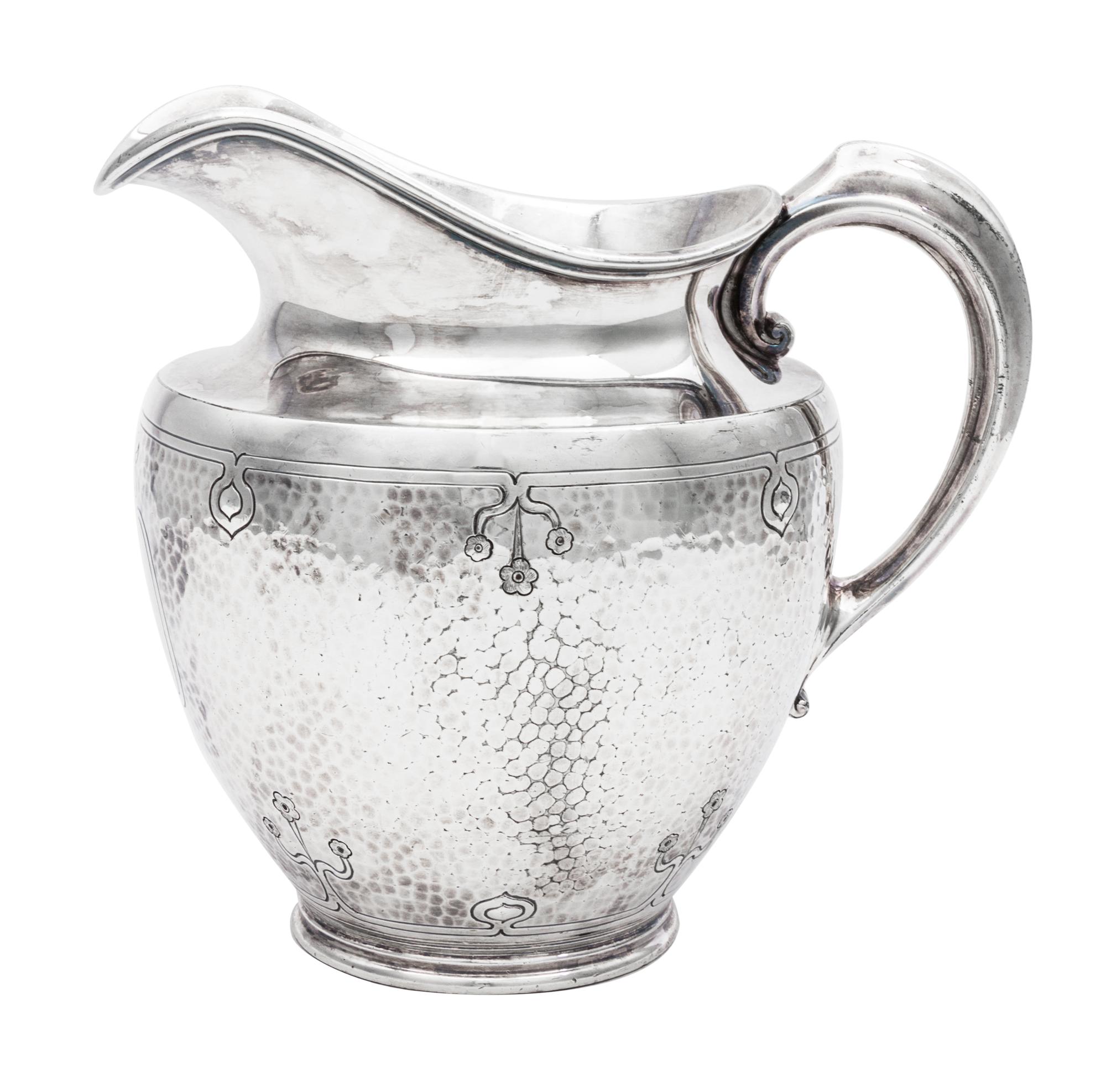 An American Arts and Crafts Silver-Plate Water Pitcher, Reed & Barton, Taunton, MA, having a spot-hammered body decorated with incised
