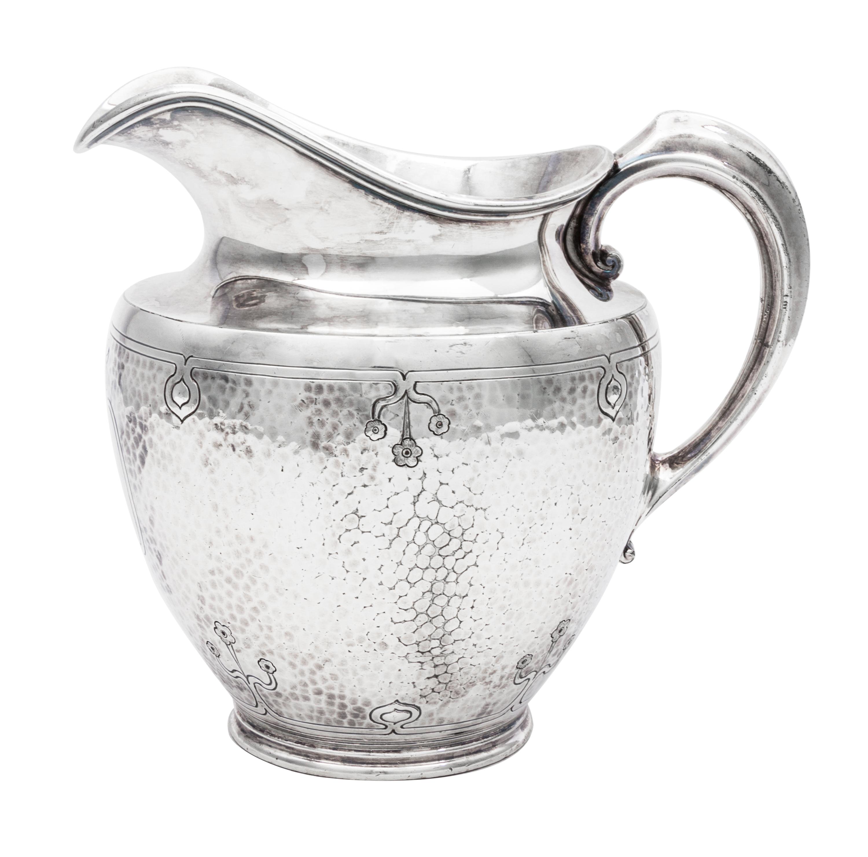An American Arts and Crafts Silver-Plate Water Pitcher, Reed & Barton, Taunton, MA, having a spot-hammered body decorated with incised