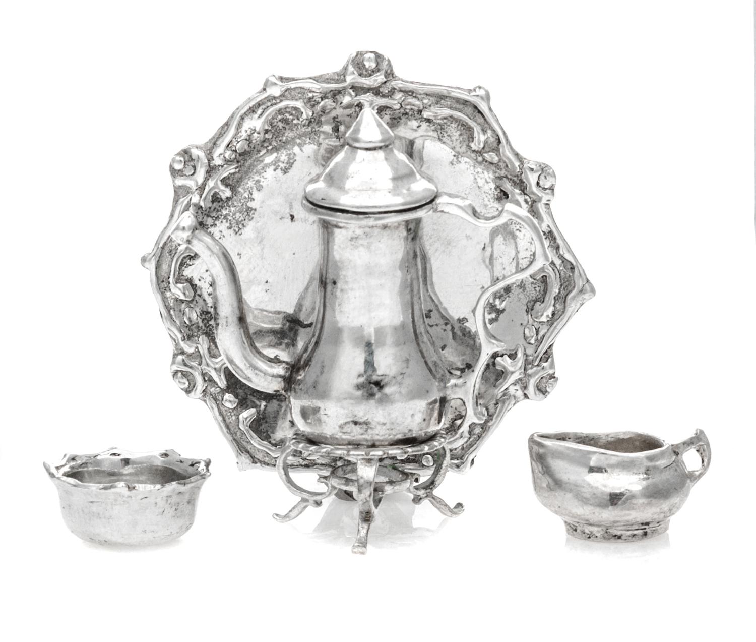 An American Silver Three-Piece Tea Service, Norma Lambert, 1977/1978, comprising a kettle on stand, a creamer, a waste bowl and a tray.