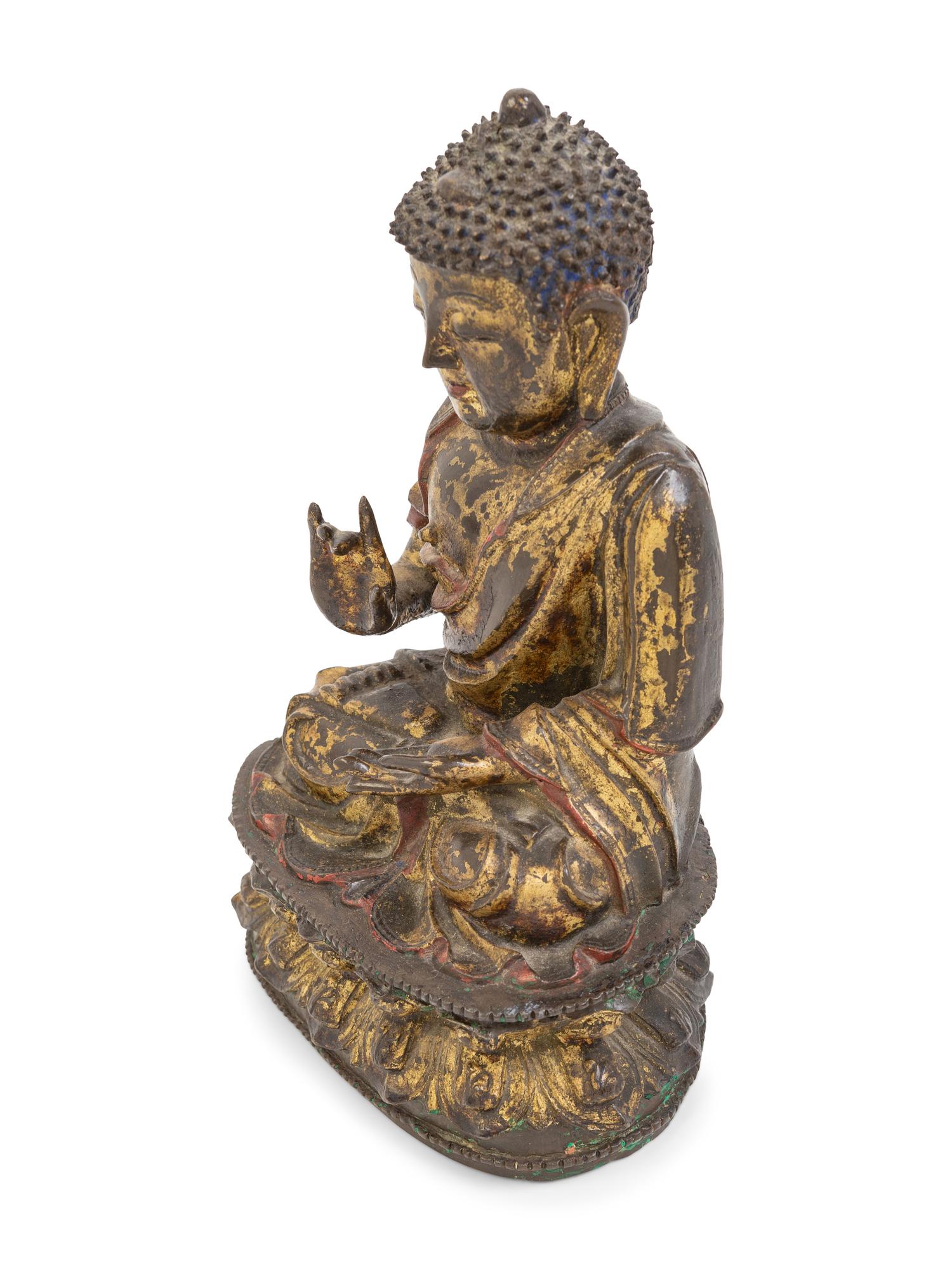 A Chinese Parcel-Gilt and Painted Bronze Figure of Seated Buddha Shakyamuni