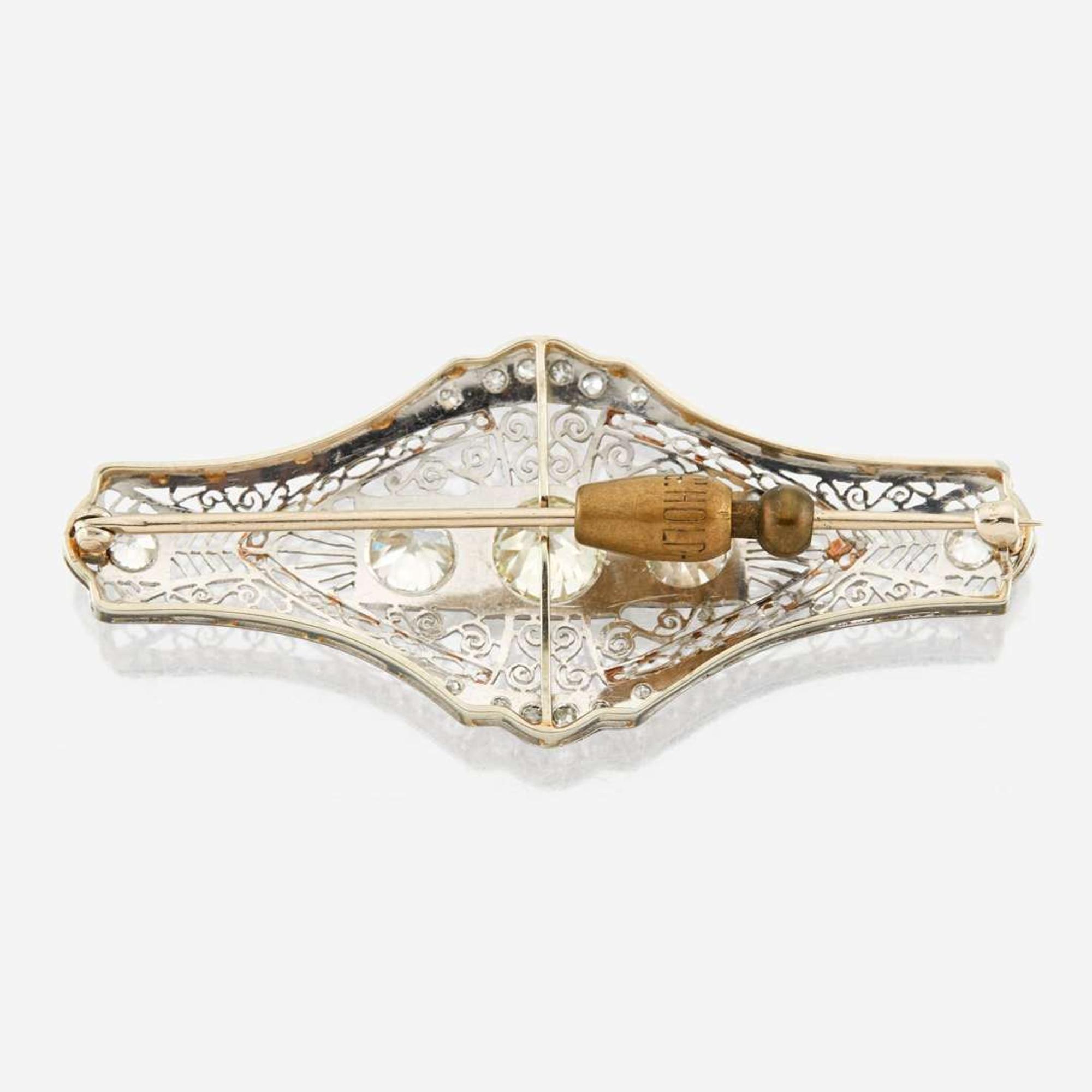 A diamond and white gold brooch