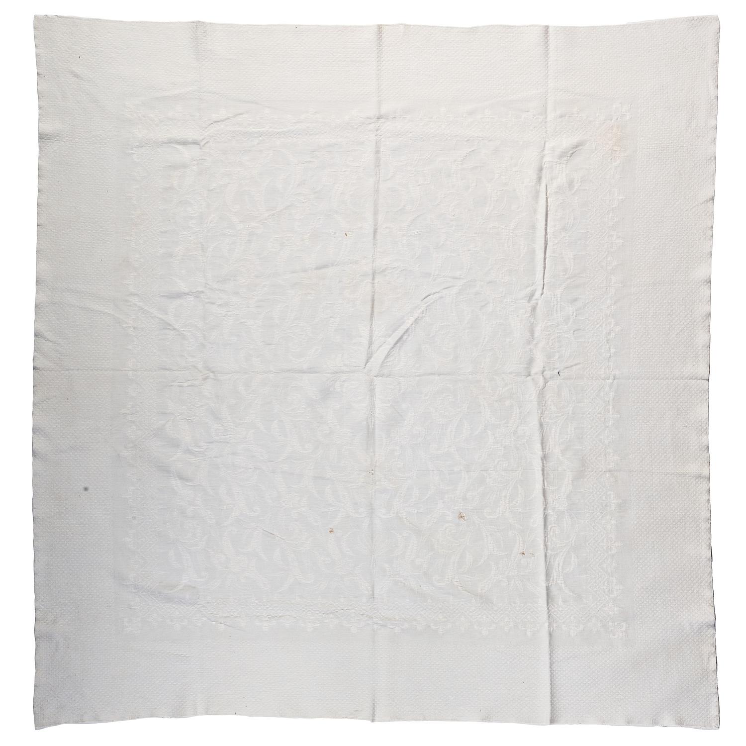 A Pieced Sunburst Quilt and a White Matelasse Coverlet