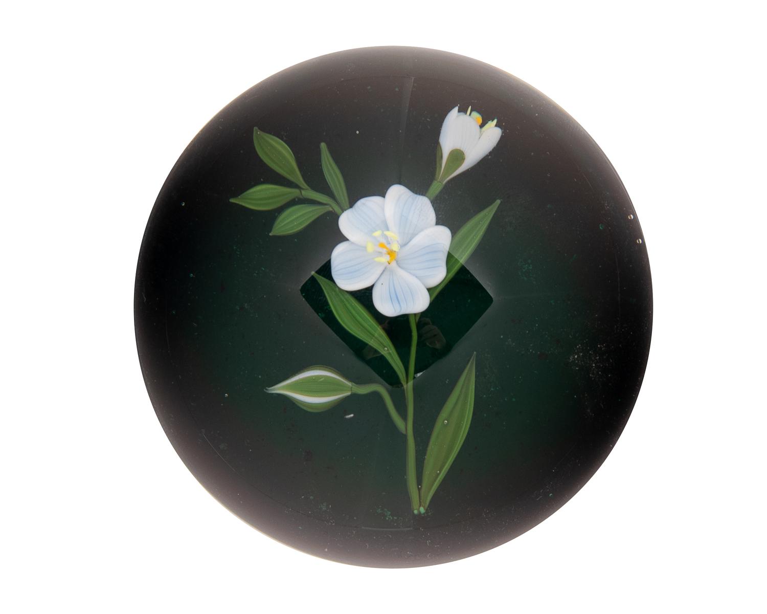 A Paul Stankard White Flower and Bud on Green Metallic Ground Glass Paperweight