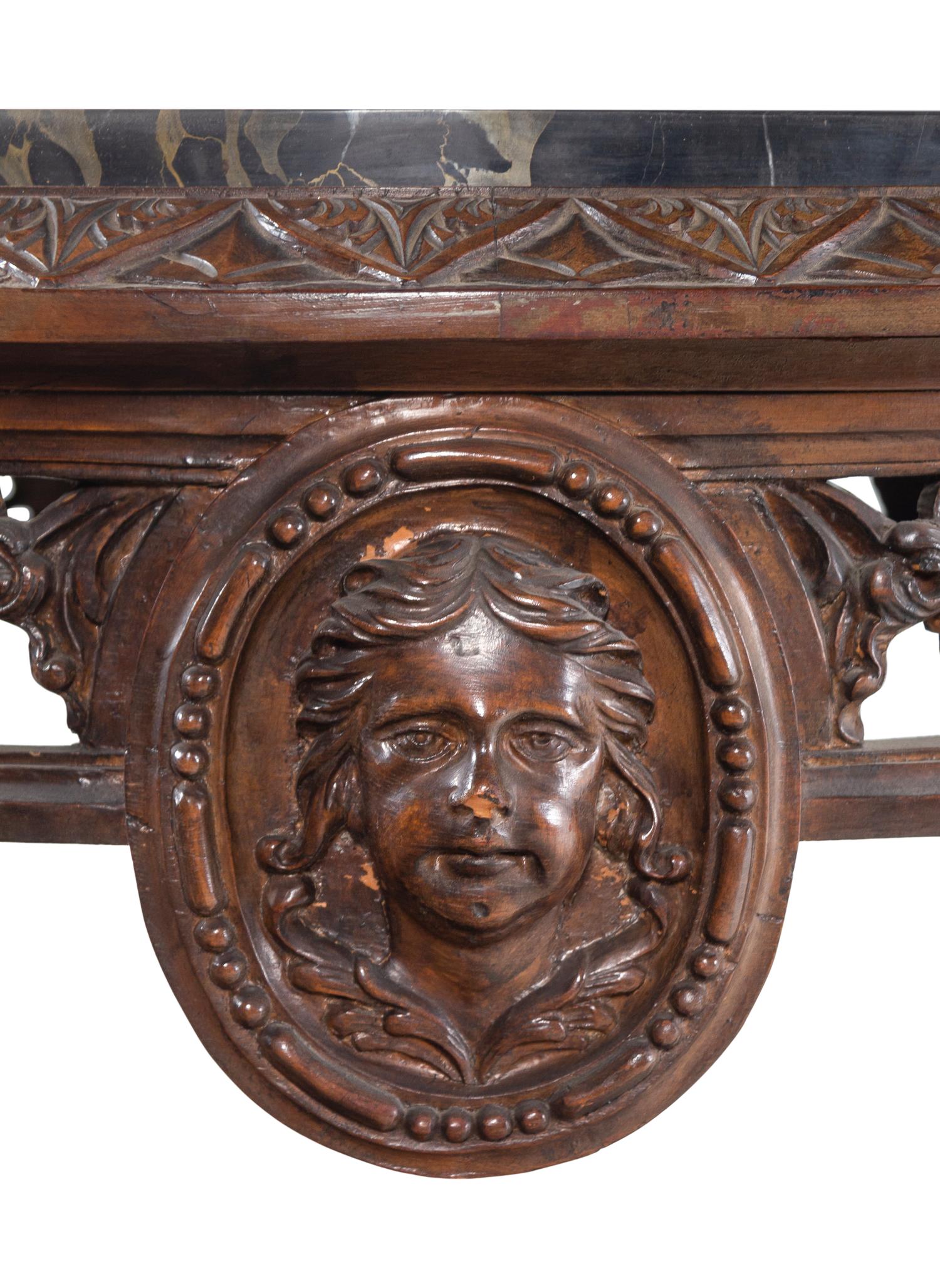 An Italian Carved Walnut Marble-Top Table
