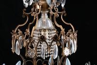 A Louis XV Style Patinated Bronze, Cut and Colored Glass Fourteen-Light Chandelier